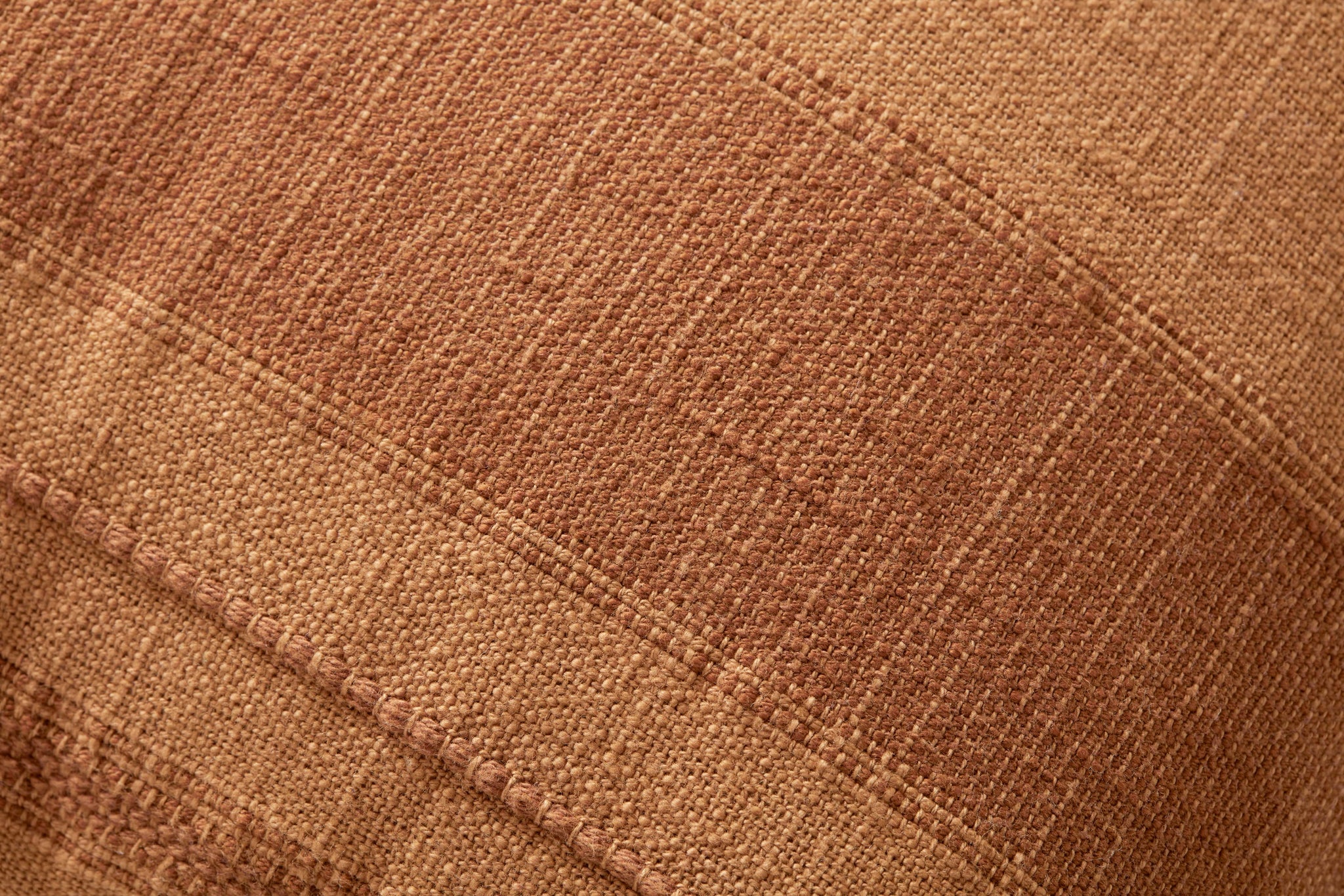 Mia Rust Pillow shown from a different angle to reveal its pattern.