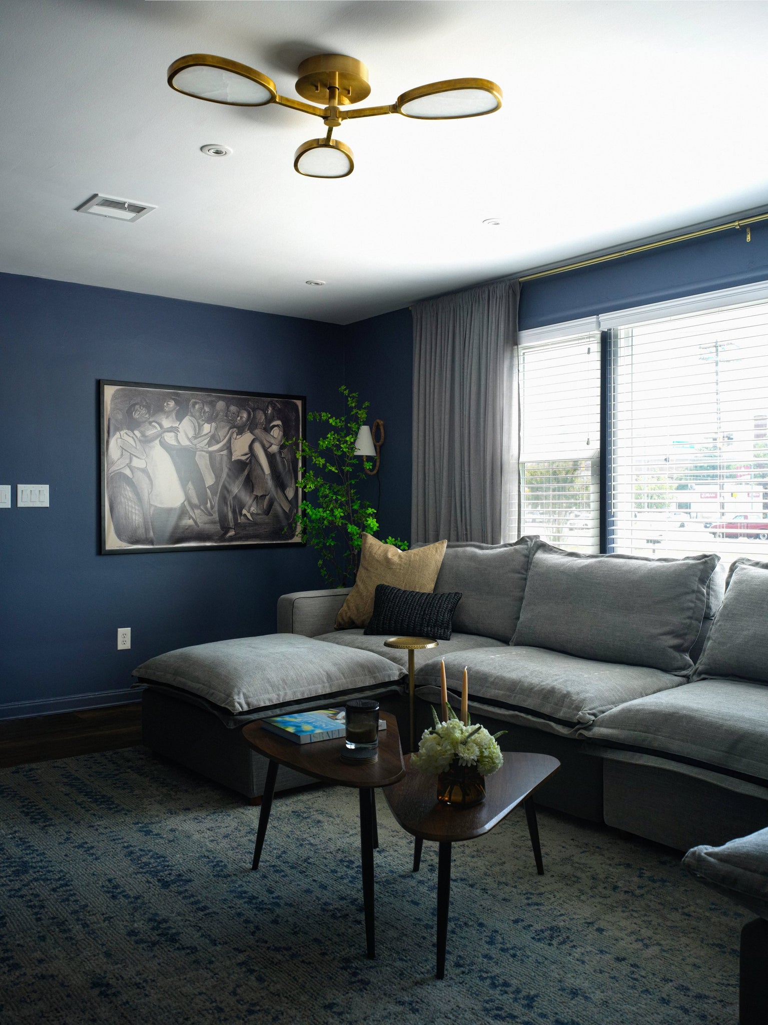 Deaver Plug-In Sconce styled in a reading nook for warm, layered light at Laurie Yapp Home.