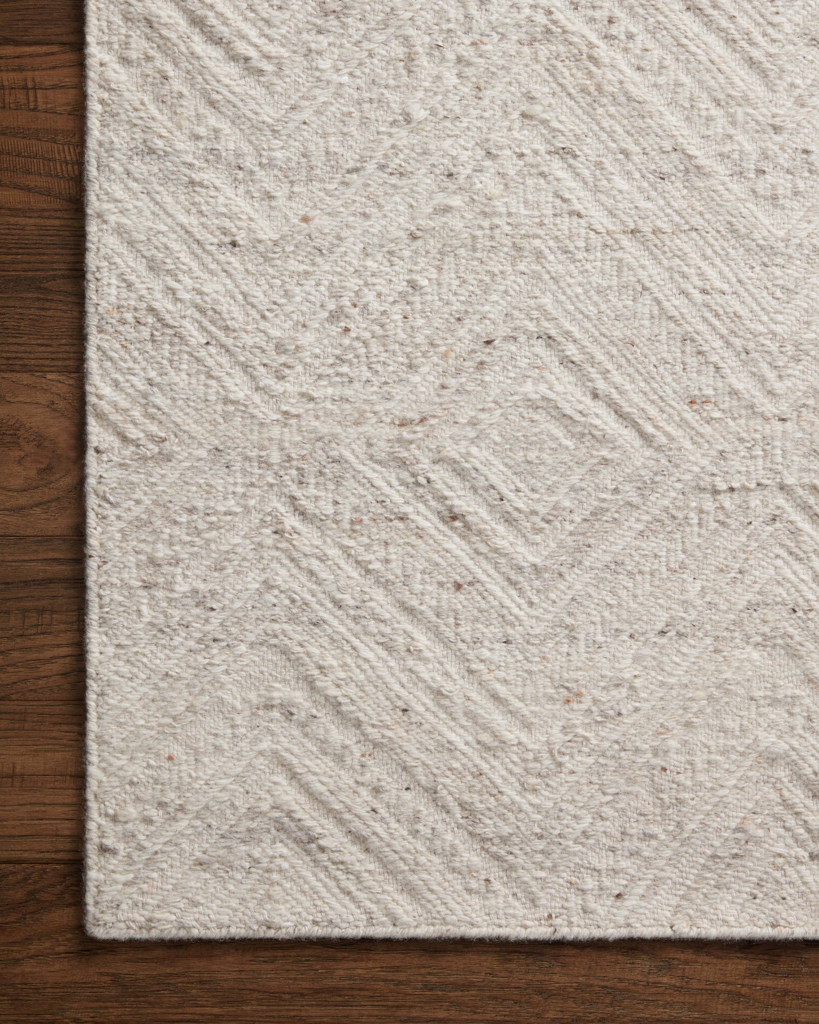 Side view of the Raven Ivory / Pebble rug.