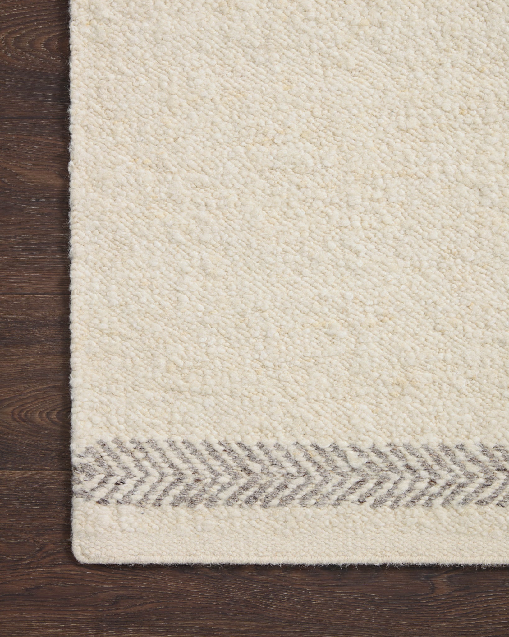Side view of the Reyla Ivory / Silver rug.