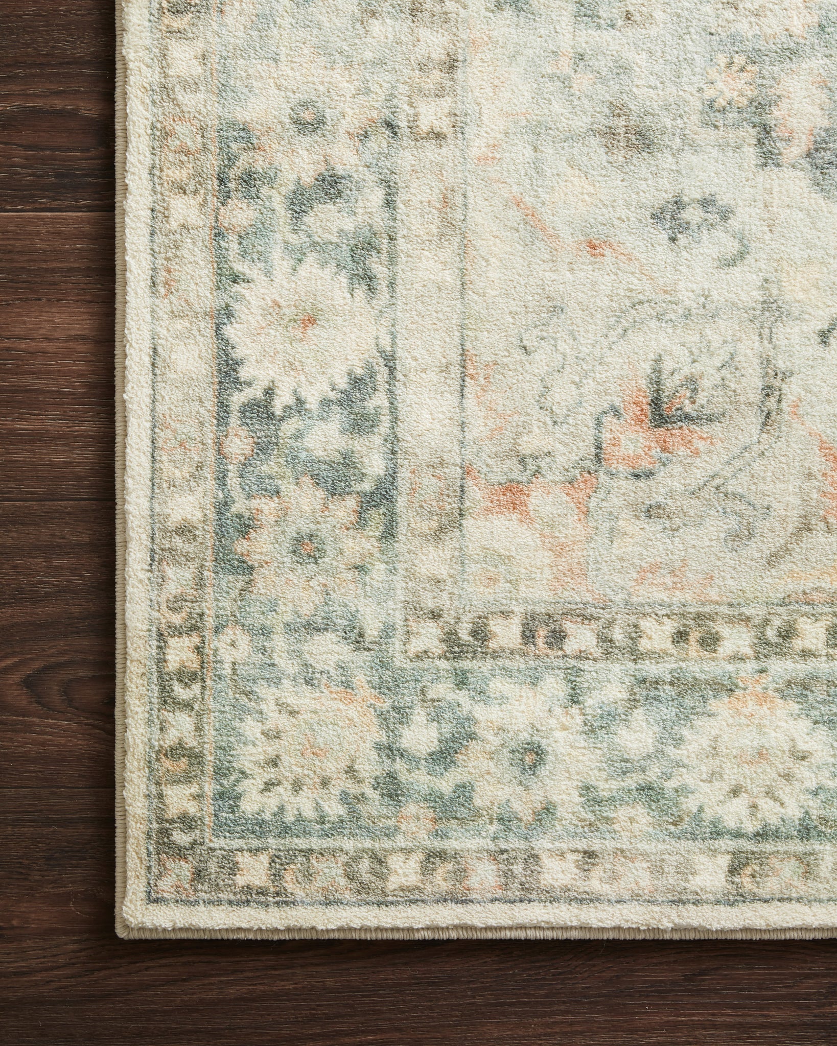 Rosette Teal / Ivory shown from a different angle to reveal its pattern.