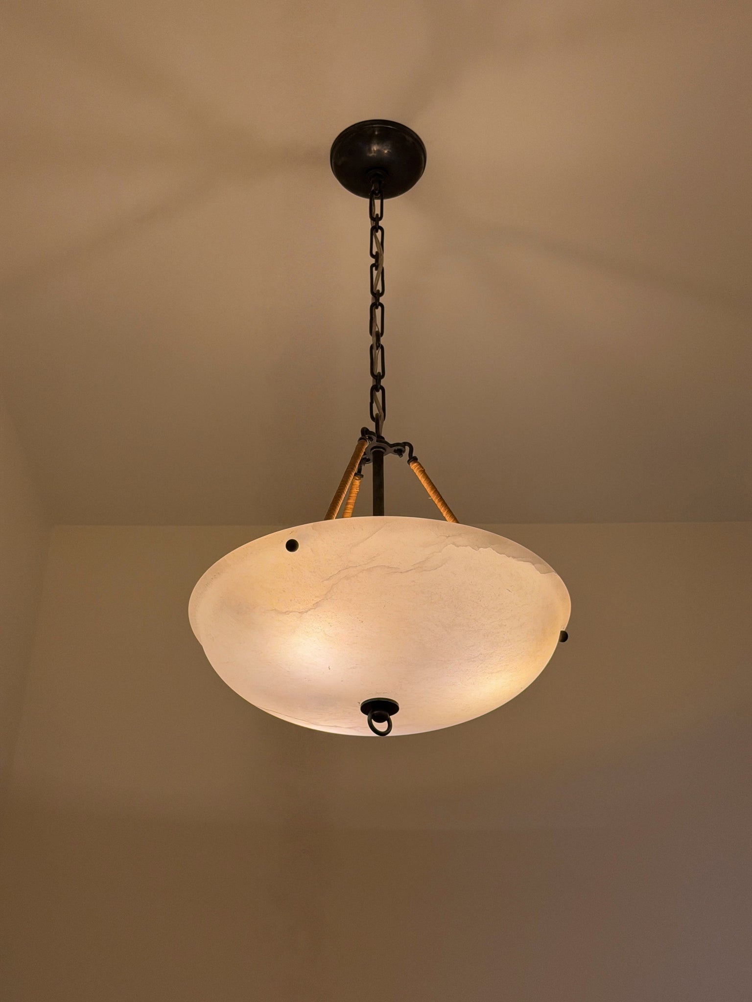 Somerset Pendant in dark bronze styled in a welcoming entryway for warm, layered light at Laurie Yapp Home.