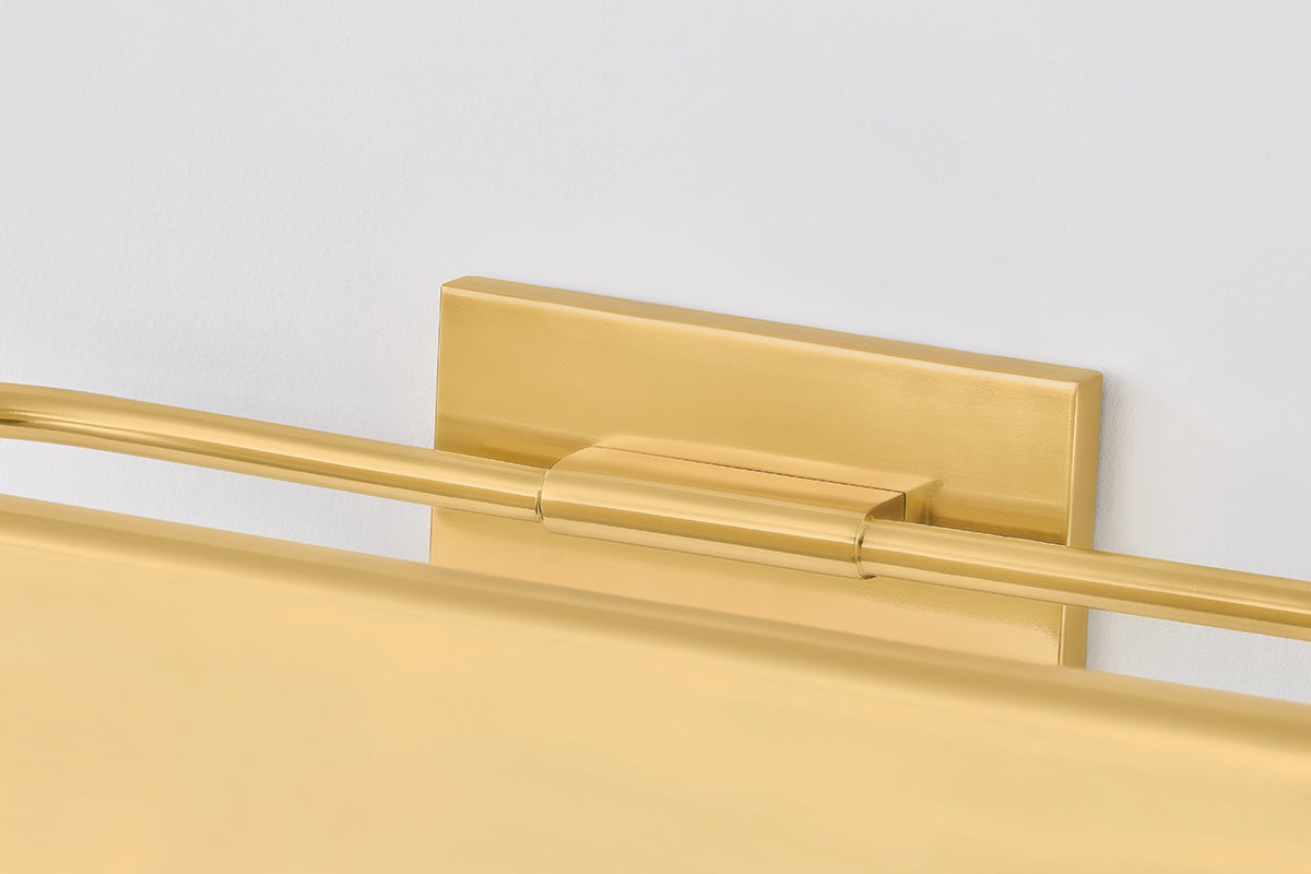 Close-up of the Tinwald Picture Light 19.25" in aged brass showing the arm curve and shade proportion.