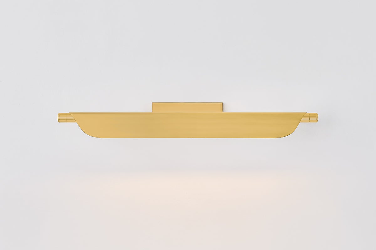Tinwald Picture Light 27" in aged brass shown from a second angle to highlight the arm curve and shade proportion.