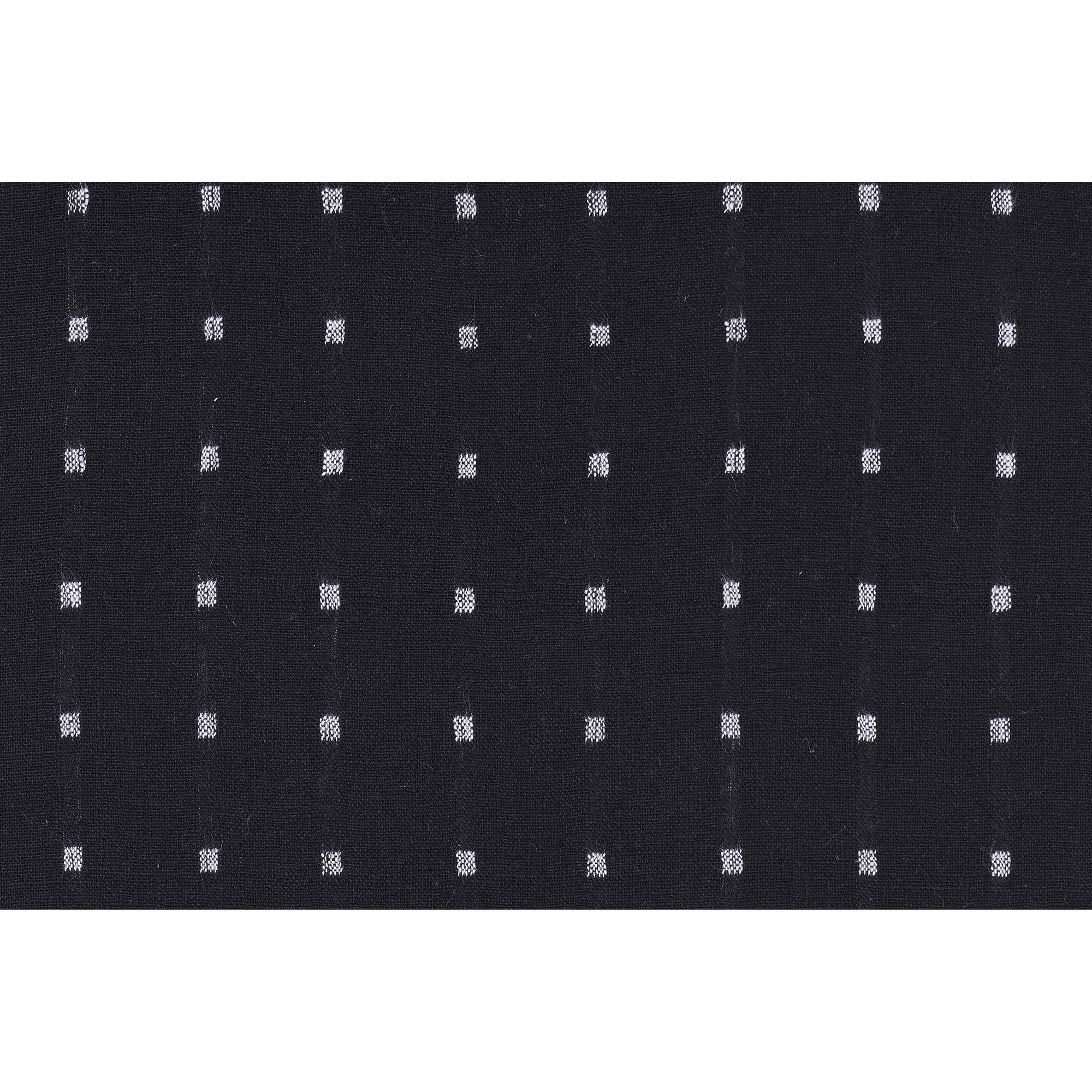 Close-up of Brittany Indoor Pillow fabric, featuring black background with white squares.