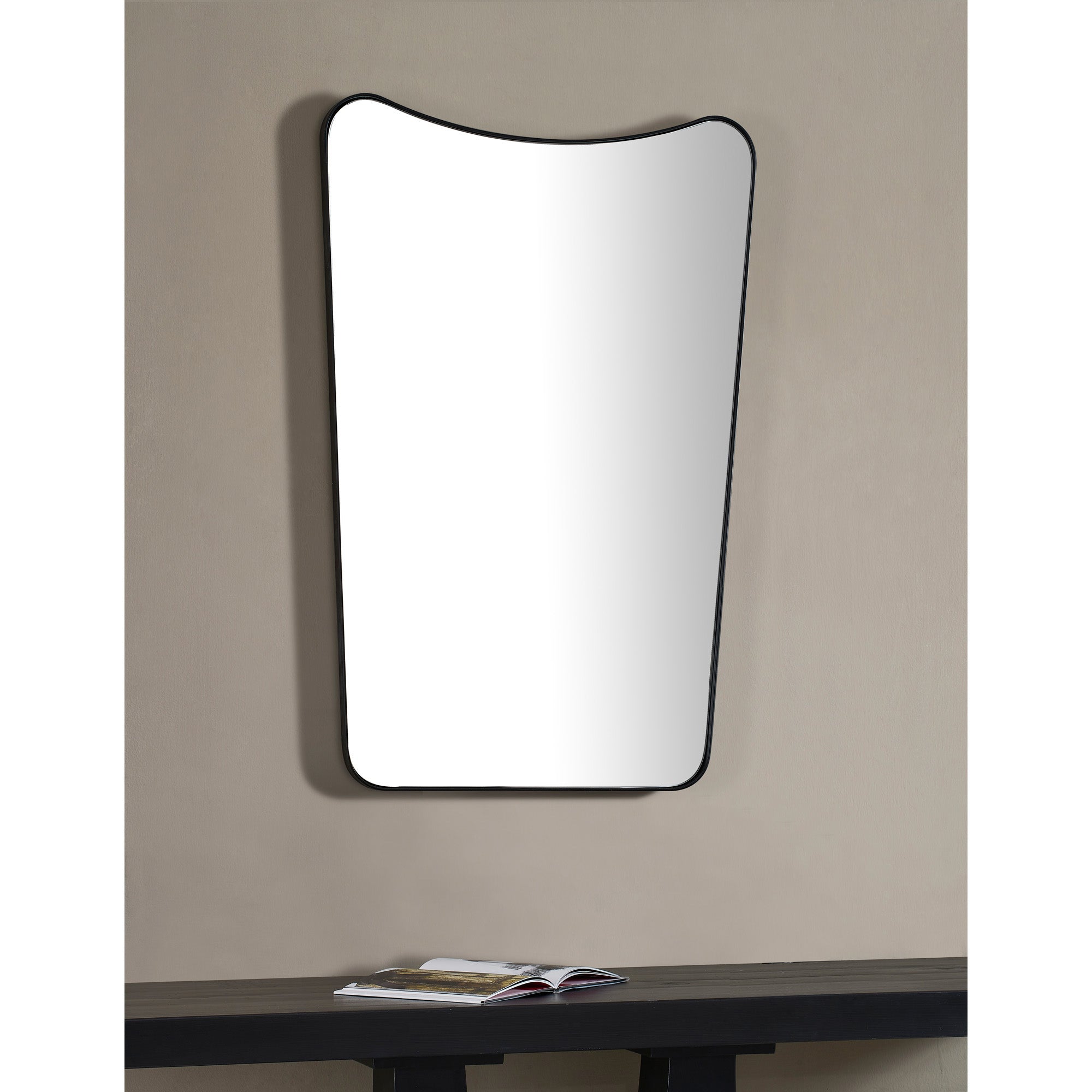 Nashua Wall Mirror mounted on a wall above a table, showcasing its modern design