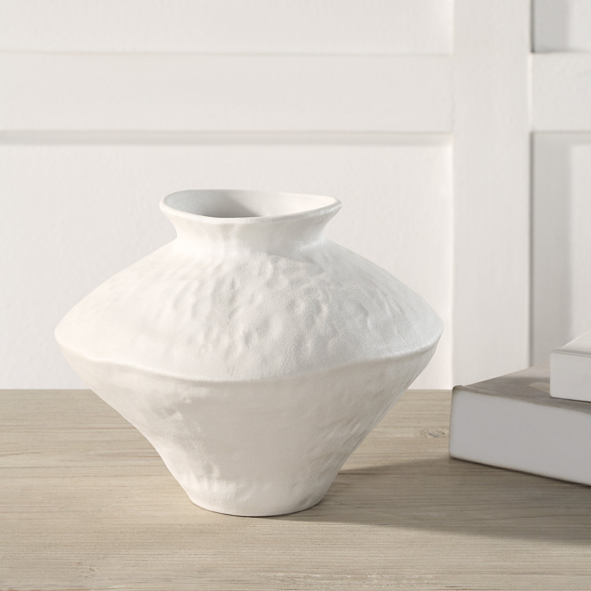 Mills Vase by Renwil, white ceramic vase displayed on a wooden table with books.