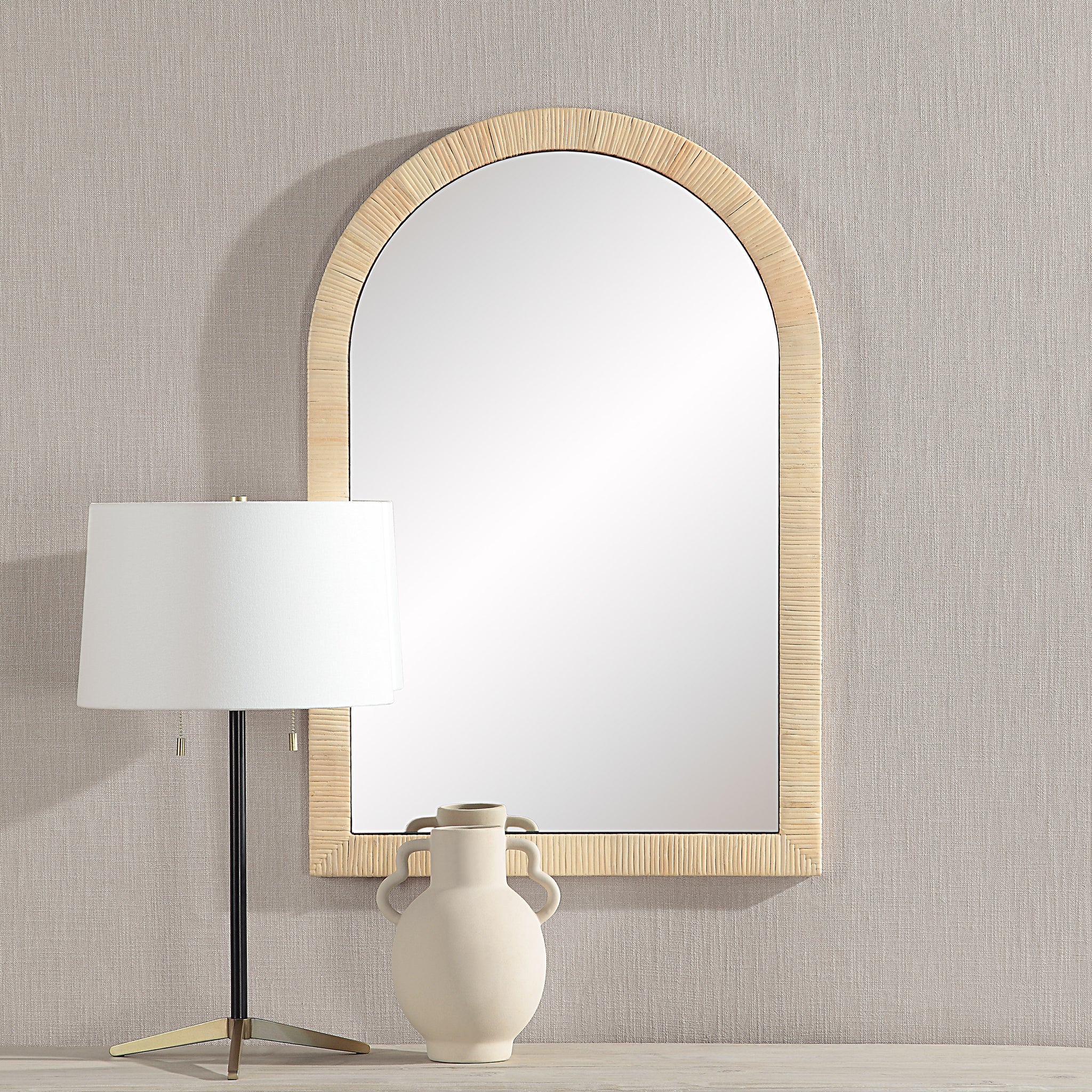 Tally Wall Mirror displayed on a wall next to a lamp and vase, showcasing its design