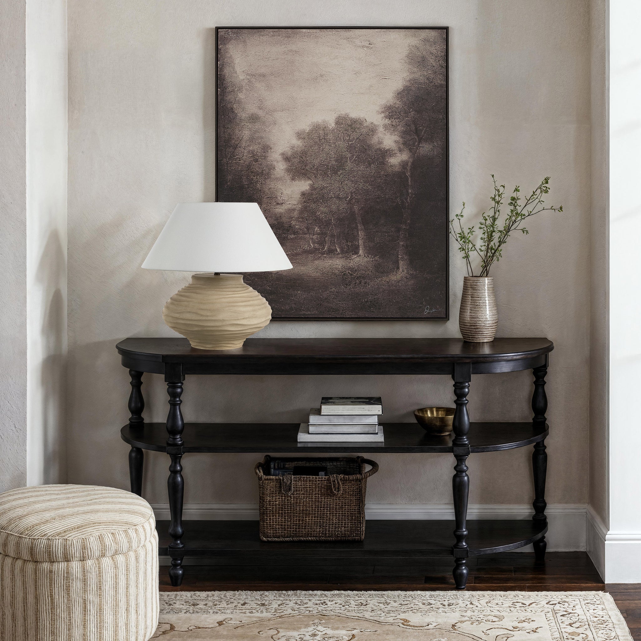 Falco canvas art featuring a serene landscape with trees in muted tones, framed and displayed above a console table.