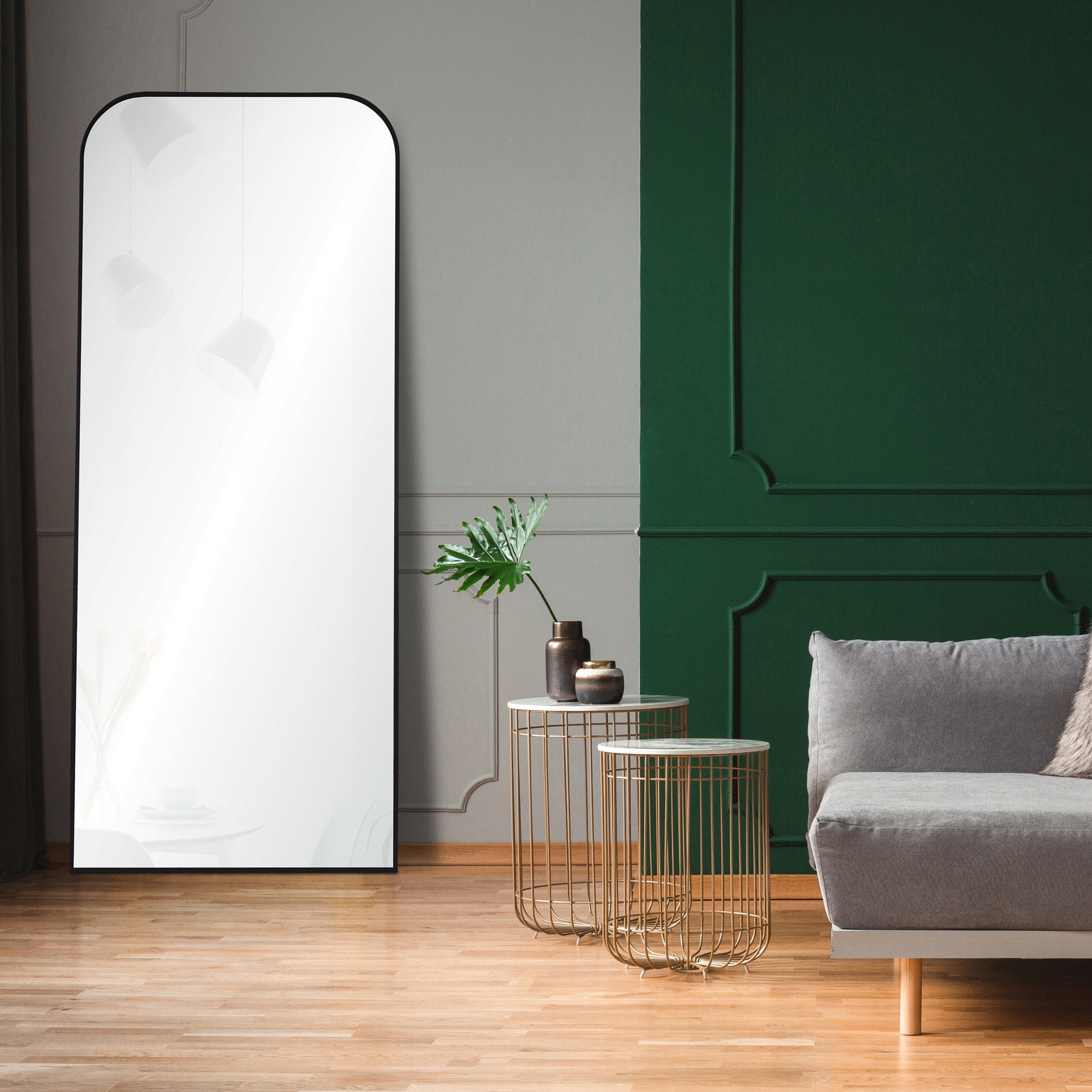 Mandret mirror by Renwil, positioned in a modern living room, black frame, reflecting interior decor.