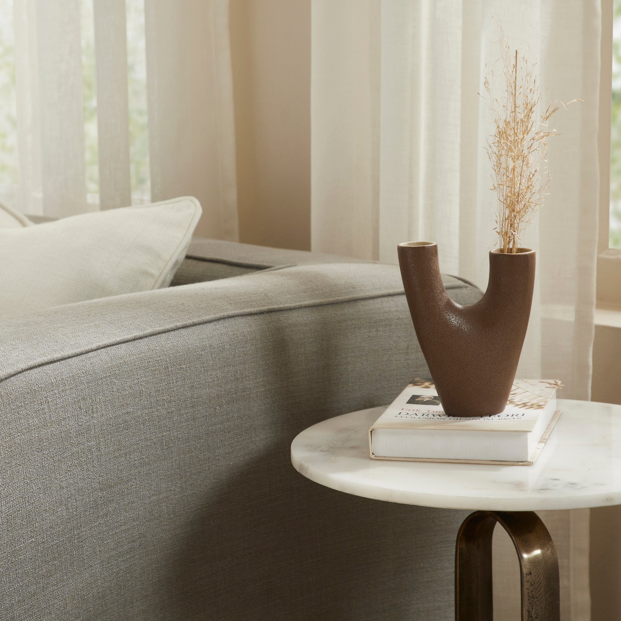 Garnier Small Vase displayed on a marble table, holding dried flowers, set in a cozy living room.