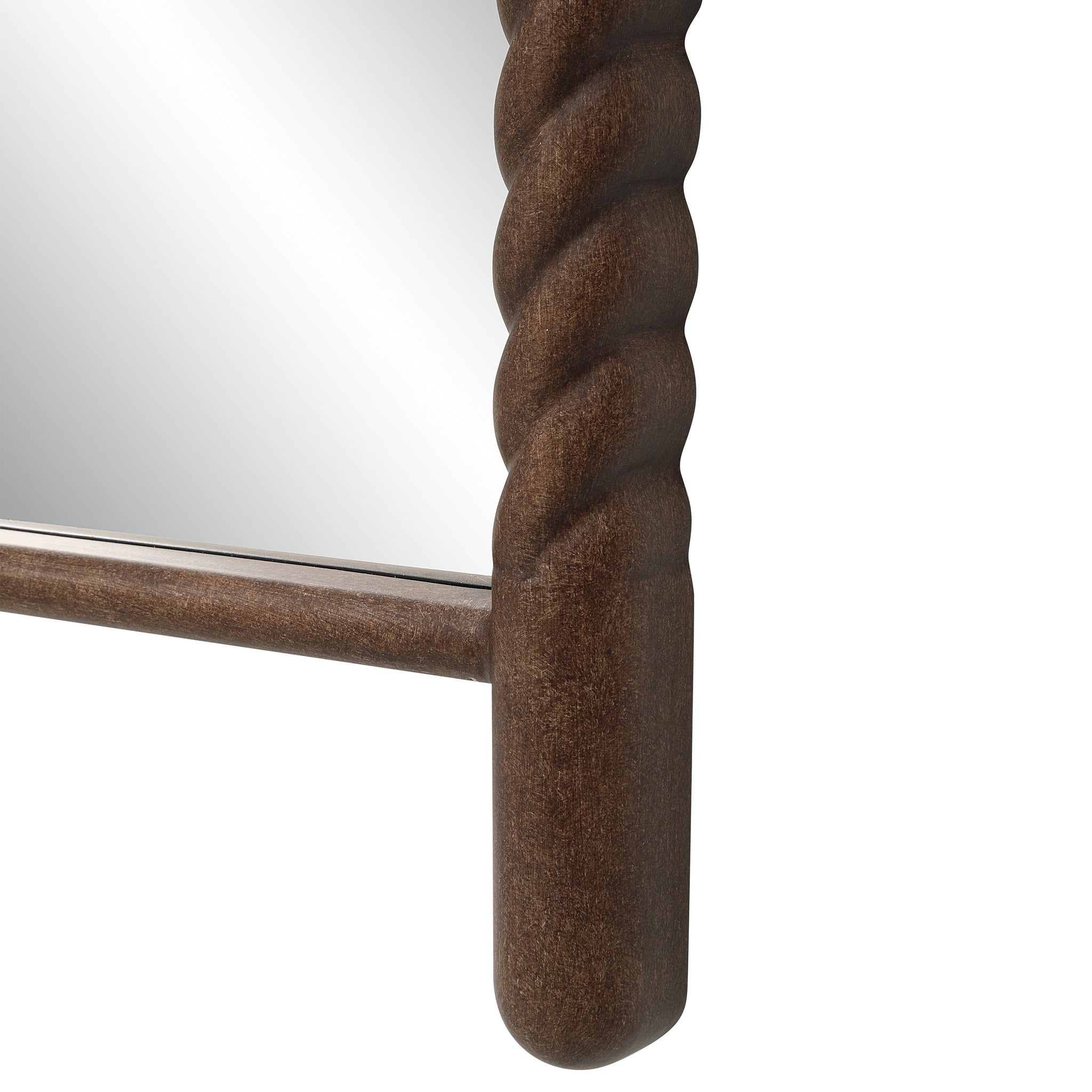 Close-up of Ignatius mirror's braided dark wood frame, highlighting texture and detail.