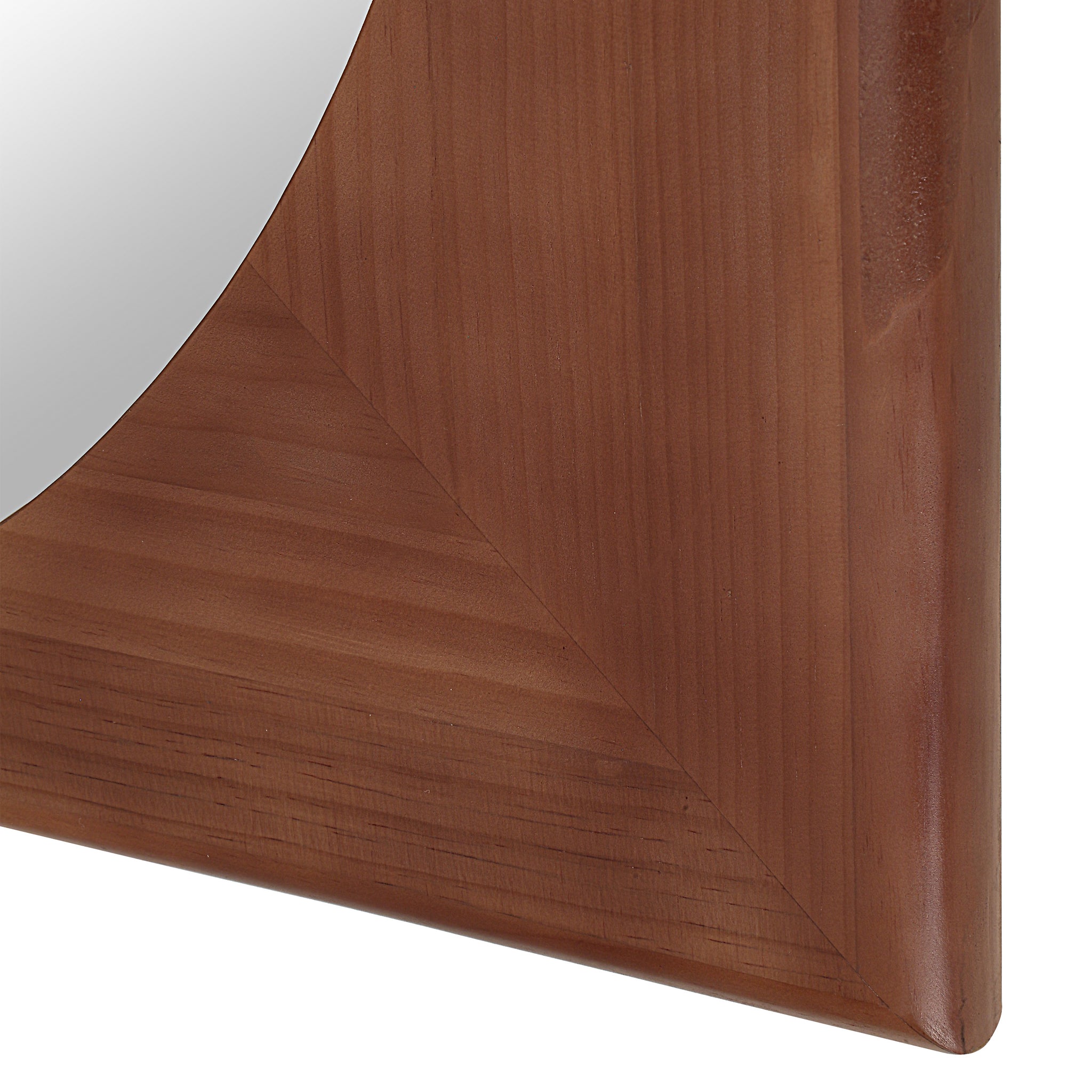 Close-up of Sitia mirror's brown wooden frame with angled corners.