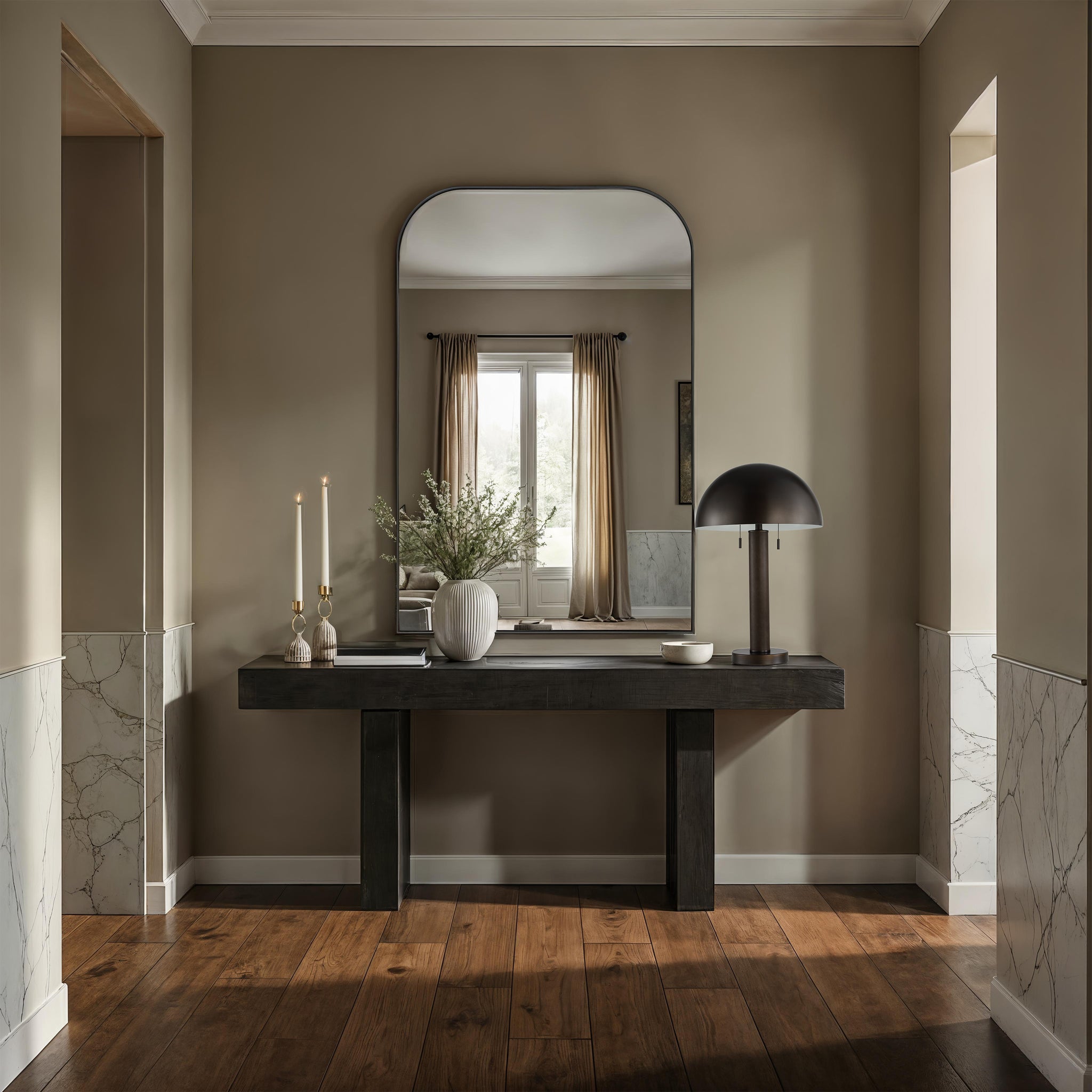 Opalina mirror in a modern entryway, featuring an arched black frame above a dark wooden console table.