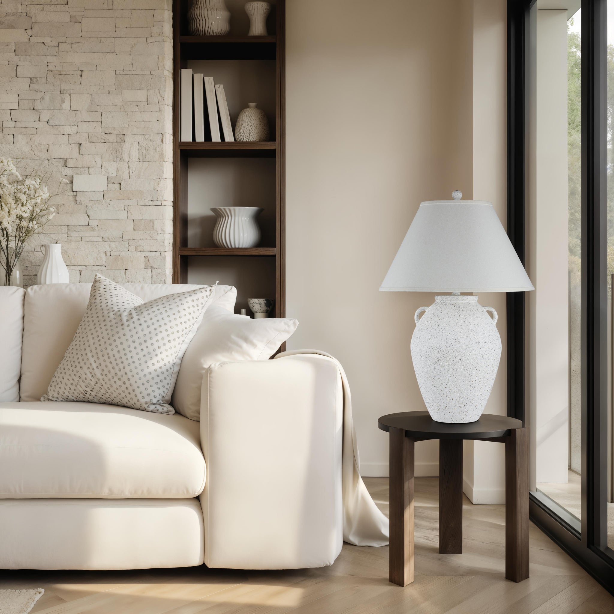 Aloria table lamp placed beside a sofa in a modern living room setting