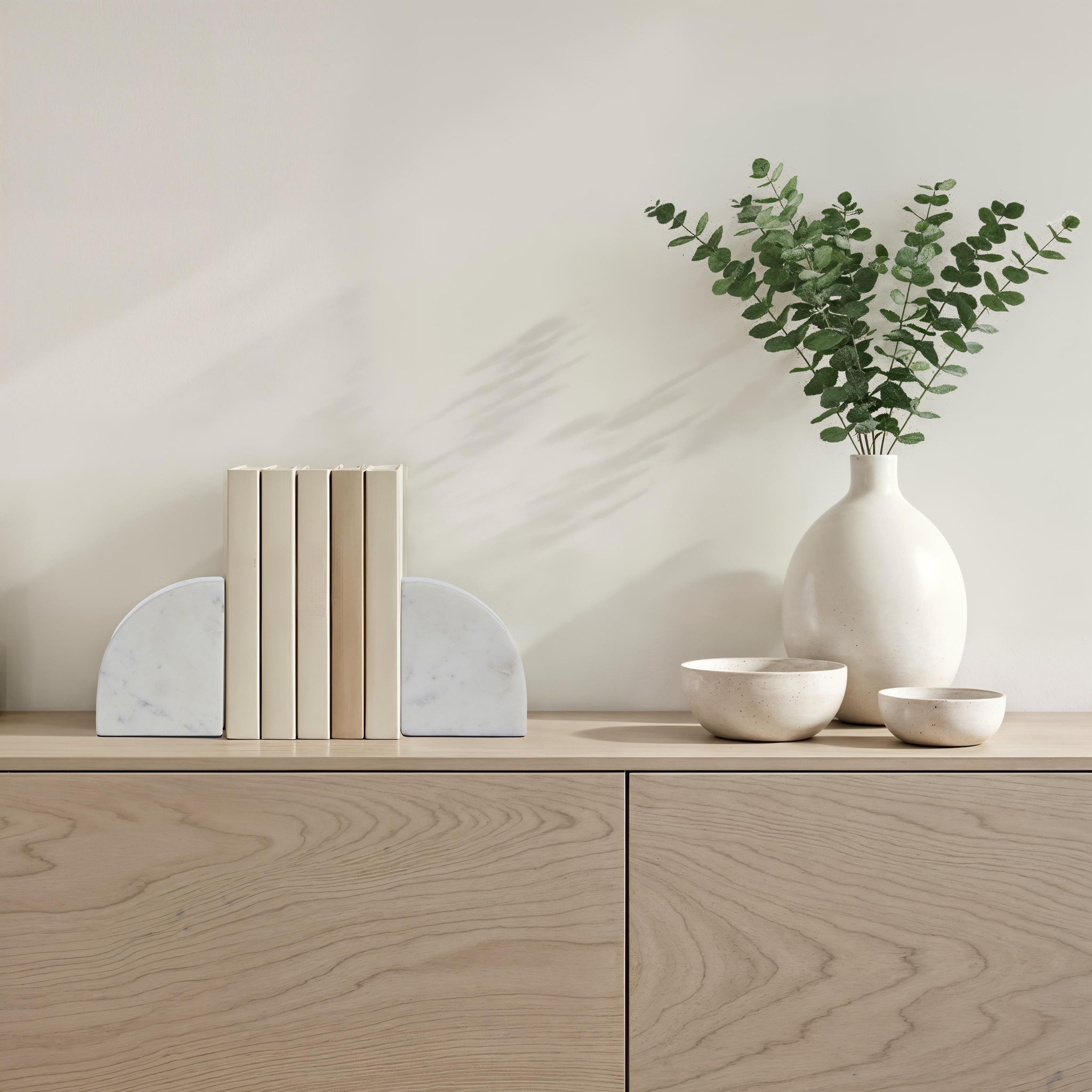 Carvella Bookends in Banswara Marble, styled with books and decorative items on a wooden shelf.