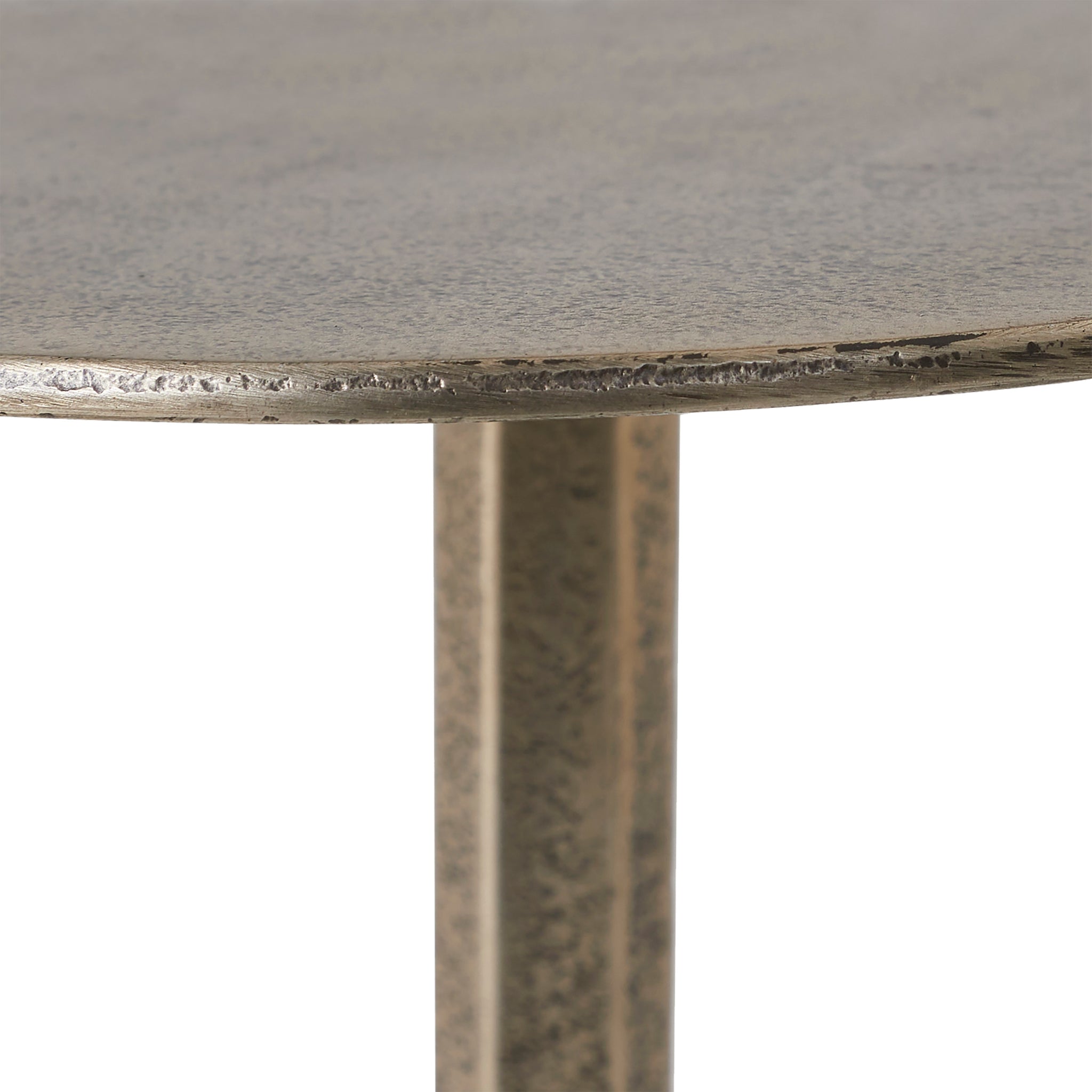 Close-up of Zahra side table's textured round top and slender metallic stem