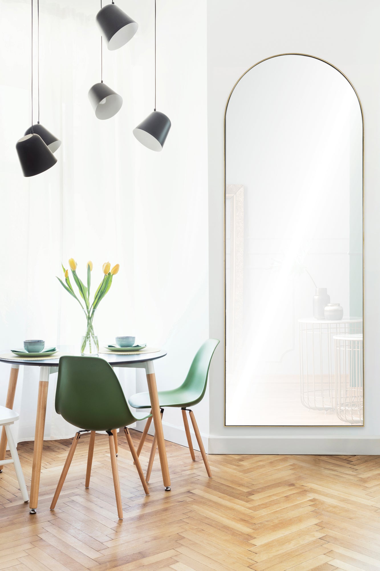 Thatcher Full Length Mirror in a bright room with a dining table and green chairs