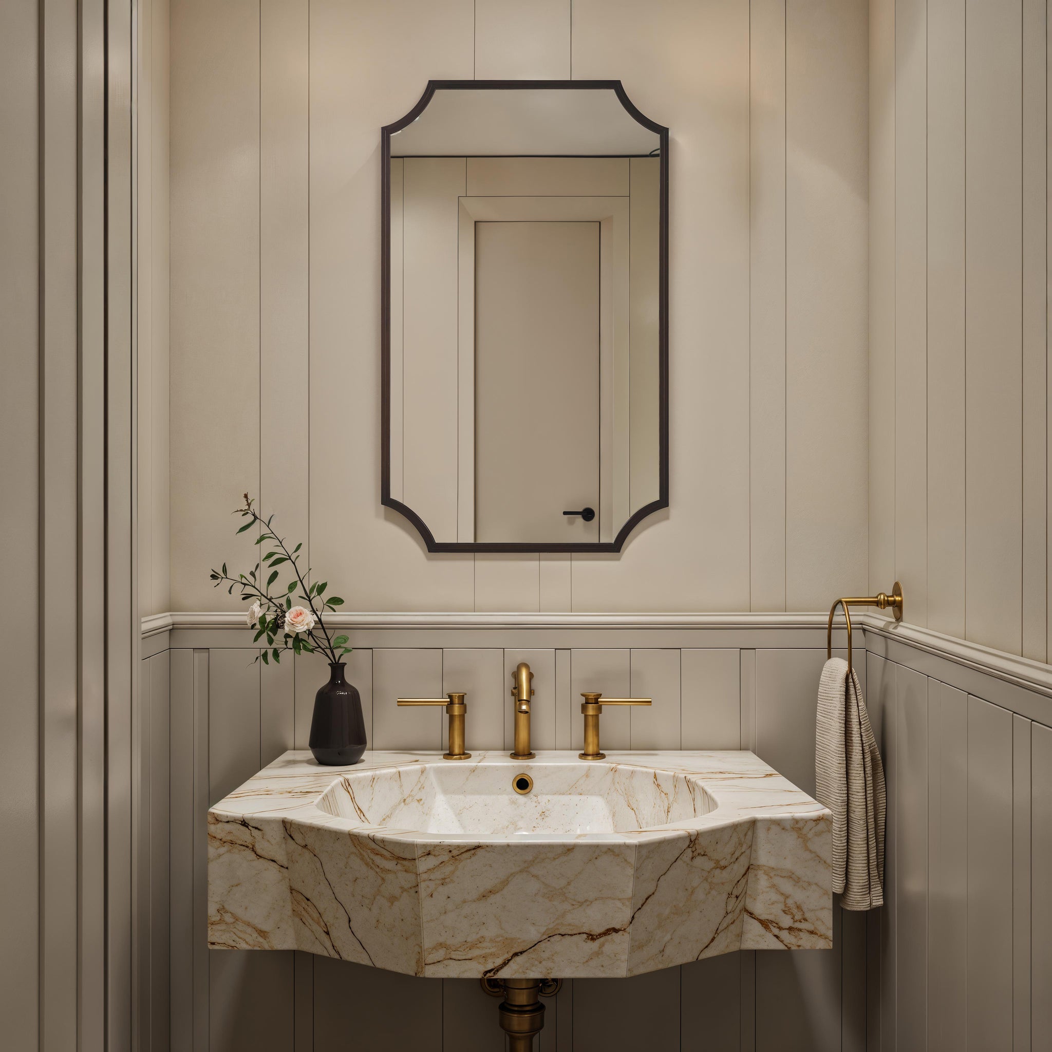 Torre mirror by Renwil in a stylish bathroom setting above a marble sink with gold fixtures.