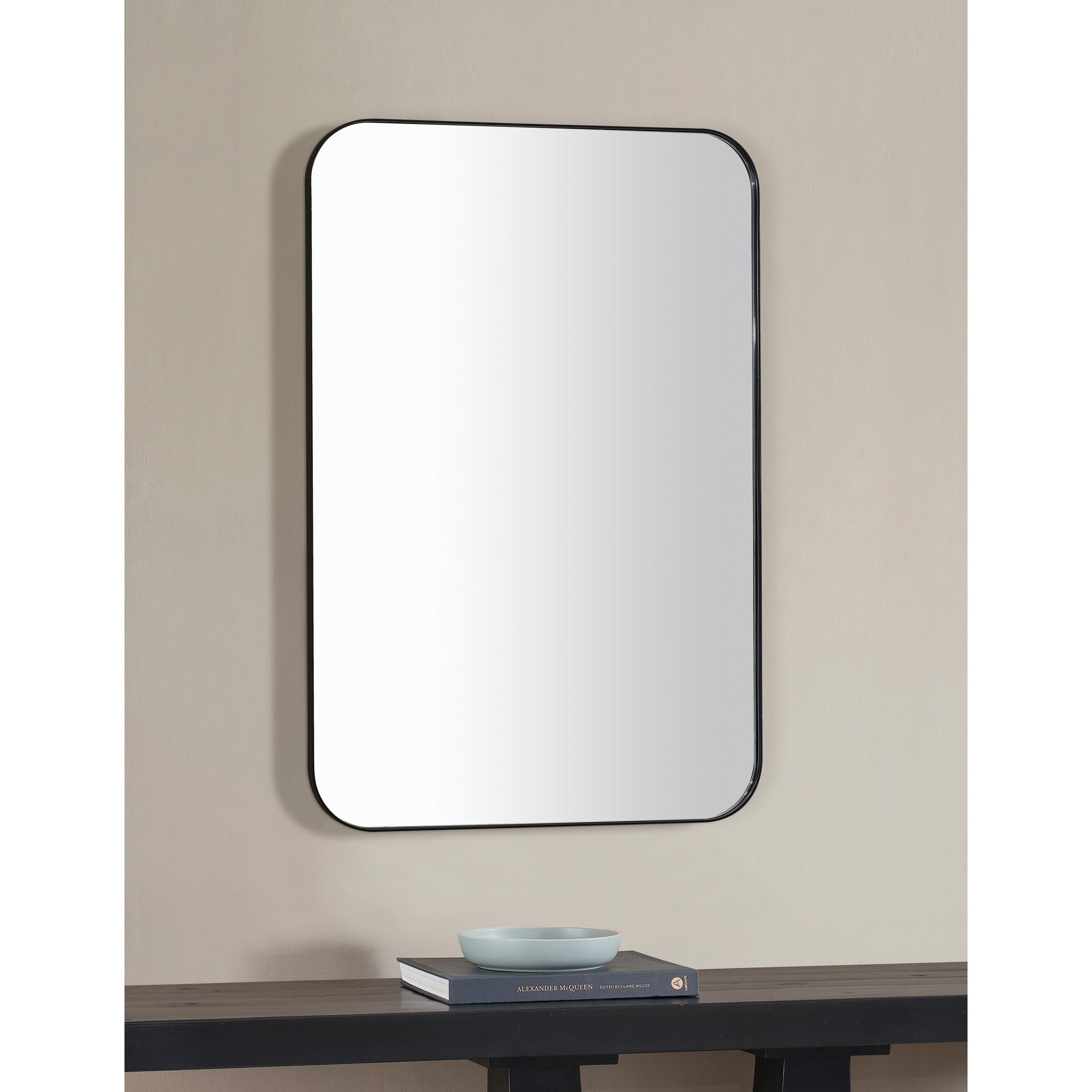 Glencoe Wall Mirror mounted on a wall above a table, displaying a modern interior setting