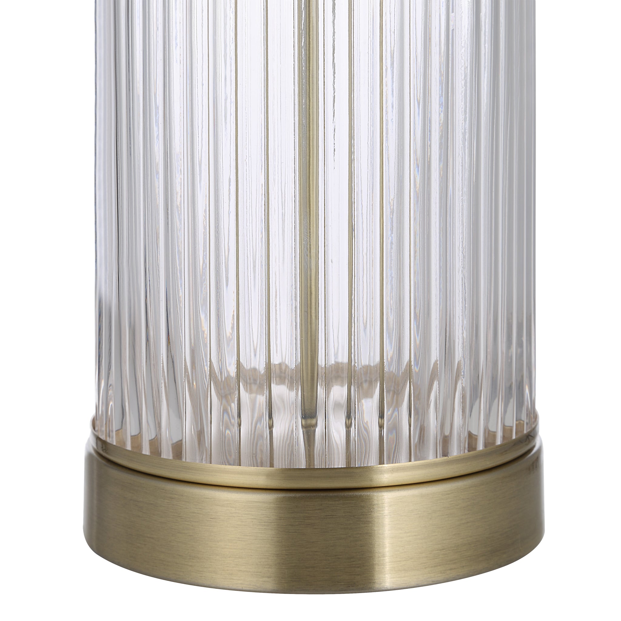 Close-up of Ocala Table Lamp's ribbed glass base with a brass accent