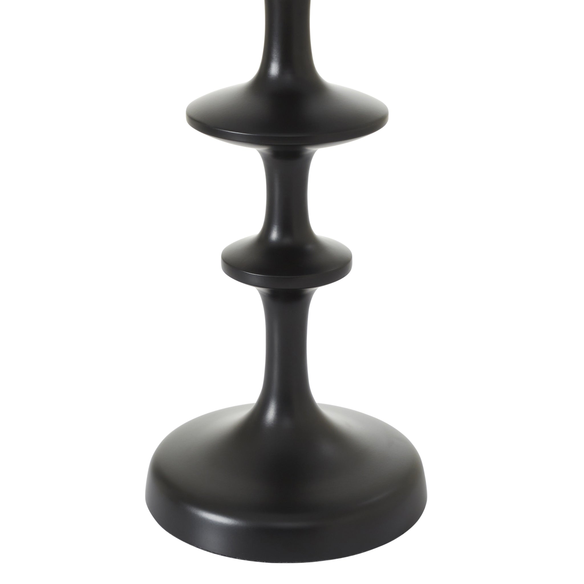Close-up of Petrus table lamp's black base with a unique stacked design and smooth finish.