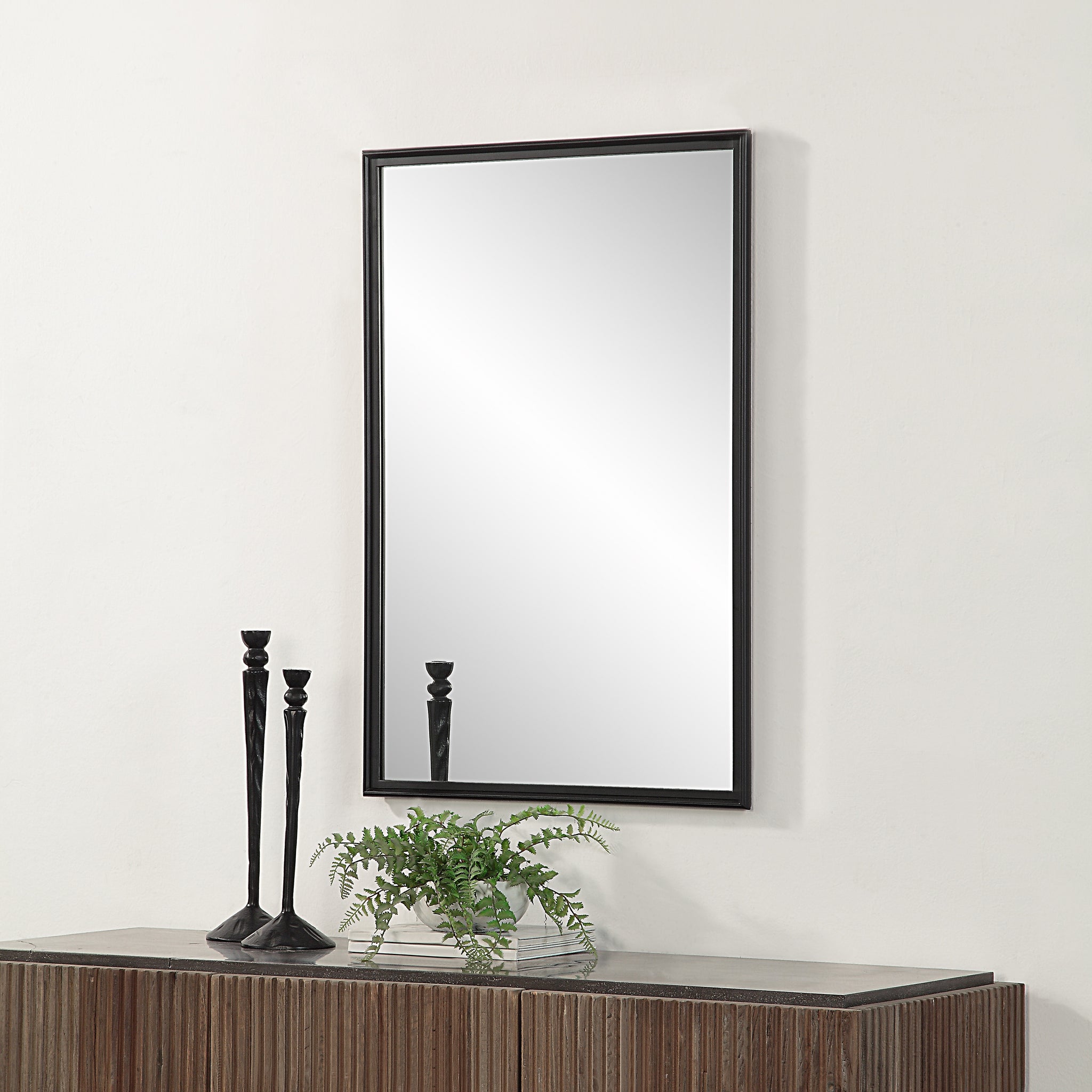 Lausanne Wall Mirror displayed above a wooden console, surrounded by decorative items.