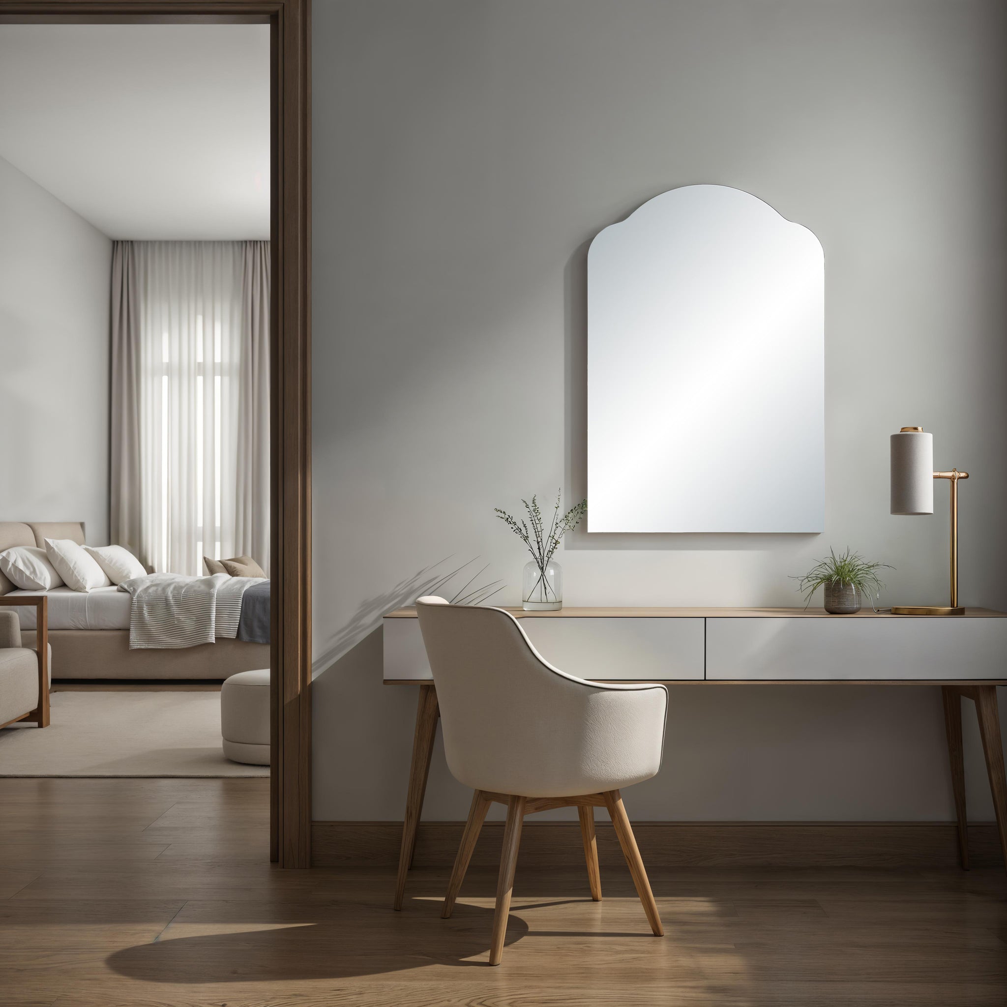 Erica mirror with an arched top, reflecting light in a modern room with a desk and chair, neutral color scheme.