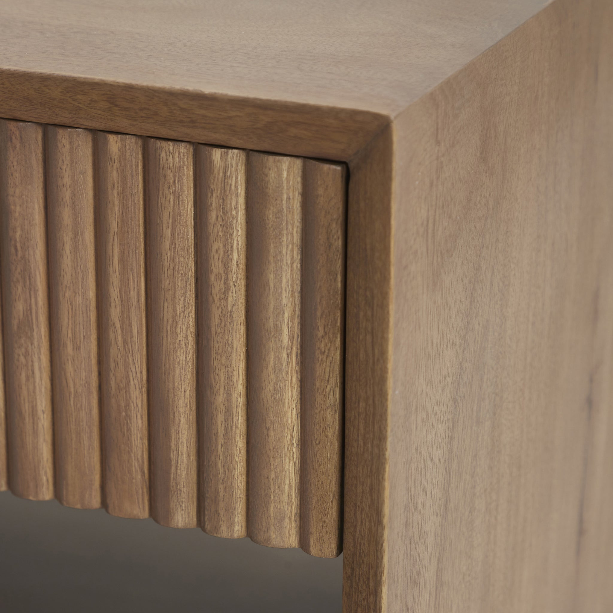 Close-up of Jaime side table showing ribbed drawer detail and smooth wood surface.