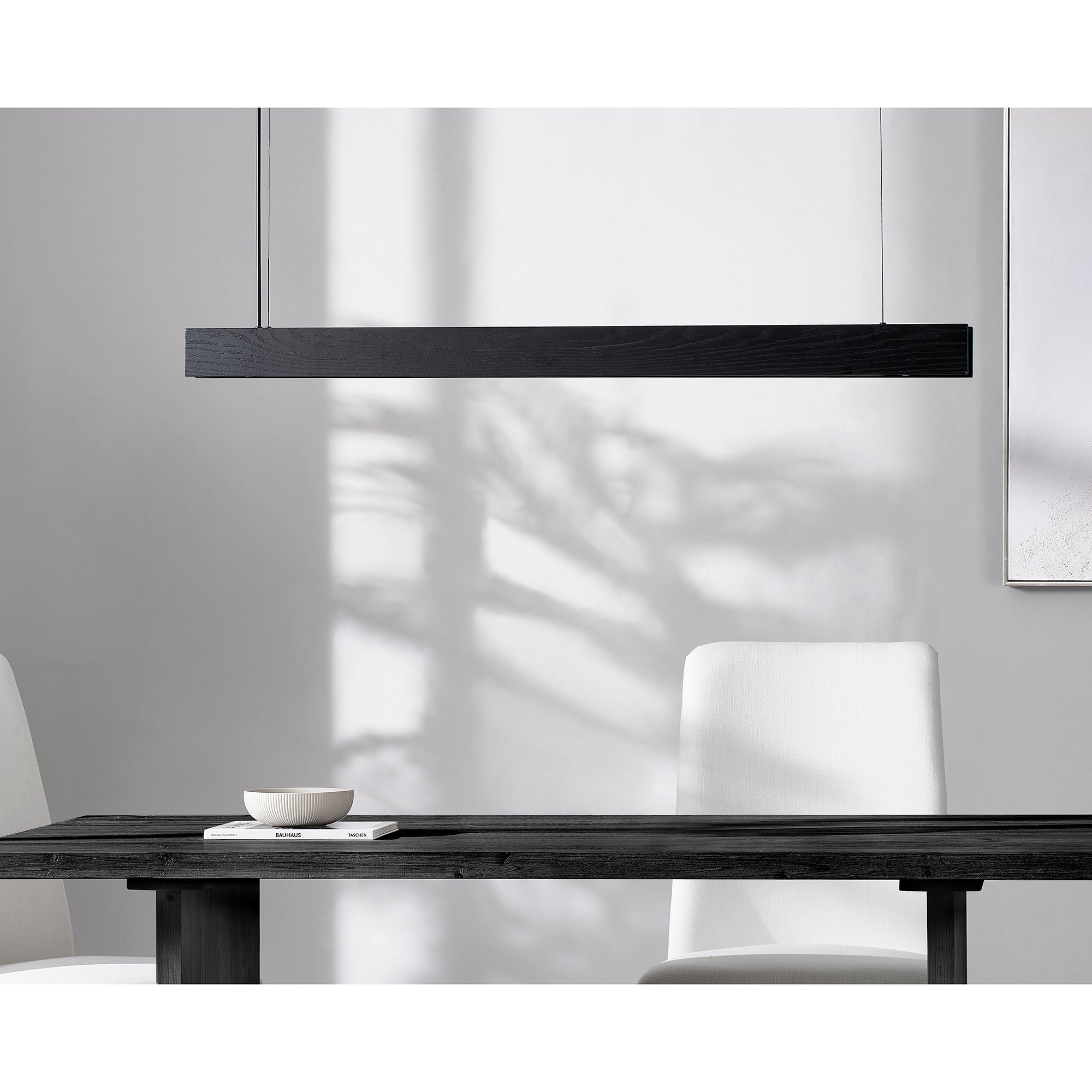 Taya Ceiling Fixture by Renwil, black wood linear light above a dining table