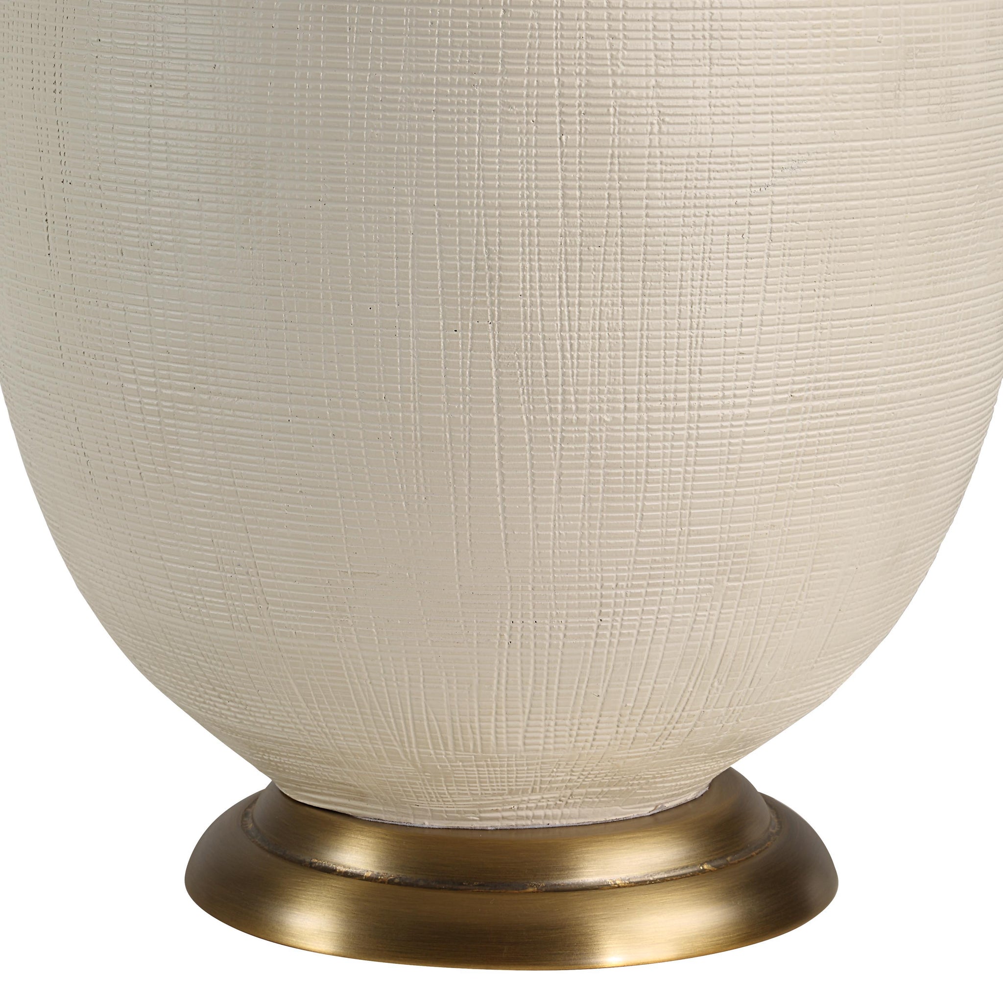 Close-up of Cartagena Table Lamp showing the textured off-white ceramic base and brass foot