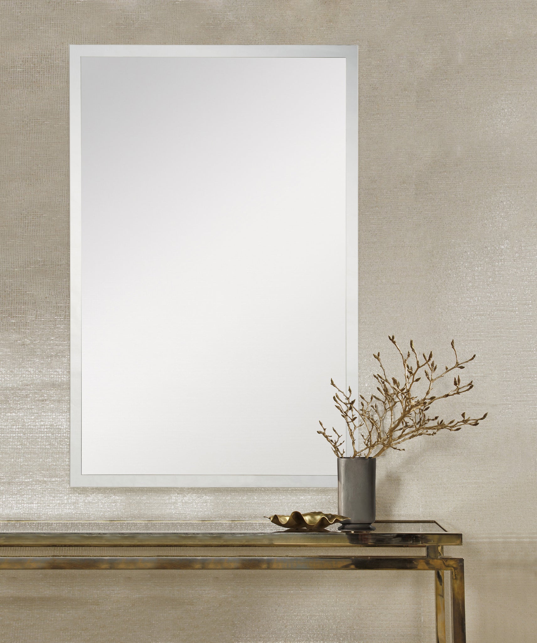 Asset Wall Mirror by Renwil displayed on a wall above a gold console table with decor