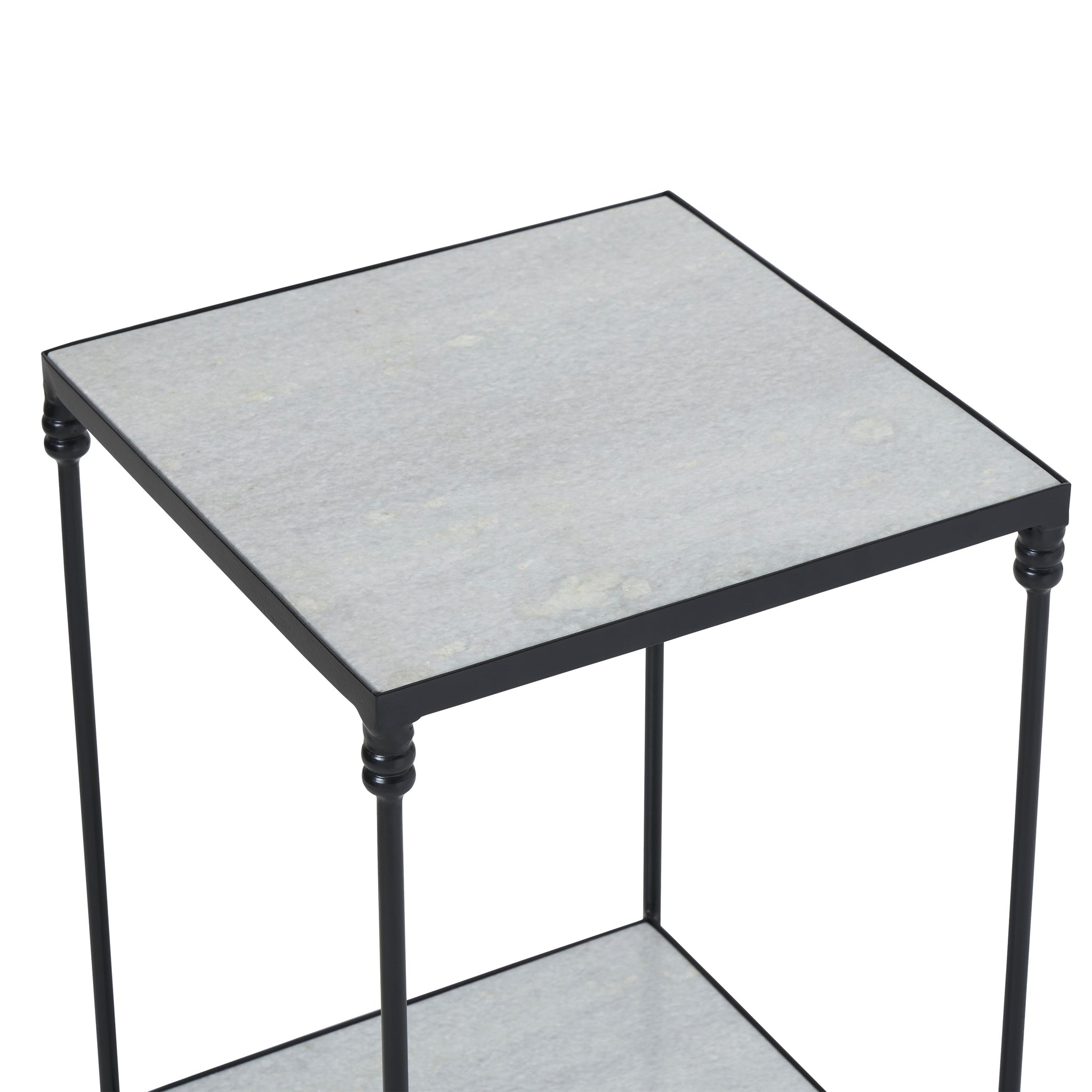Giulia table with a light gray stone top and black metal frame, viewed from above.