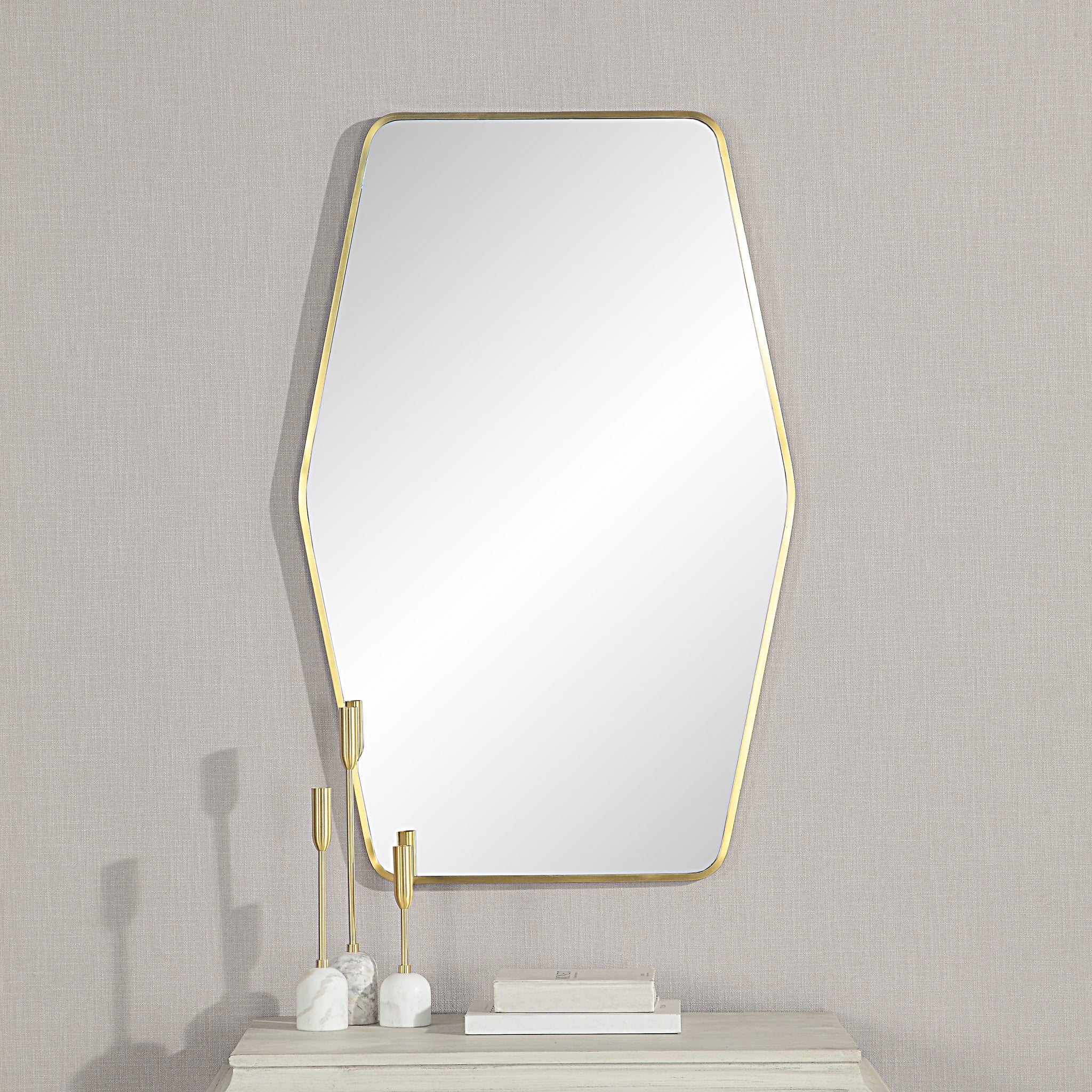 Mocha Wall Mirror displayed on a wall with decorative items on a table below