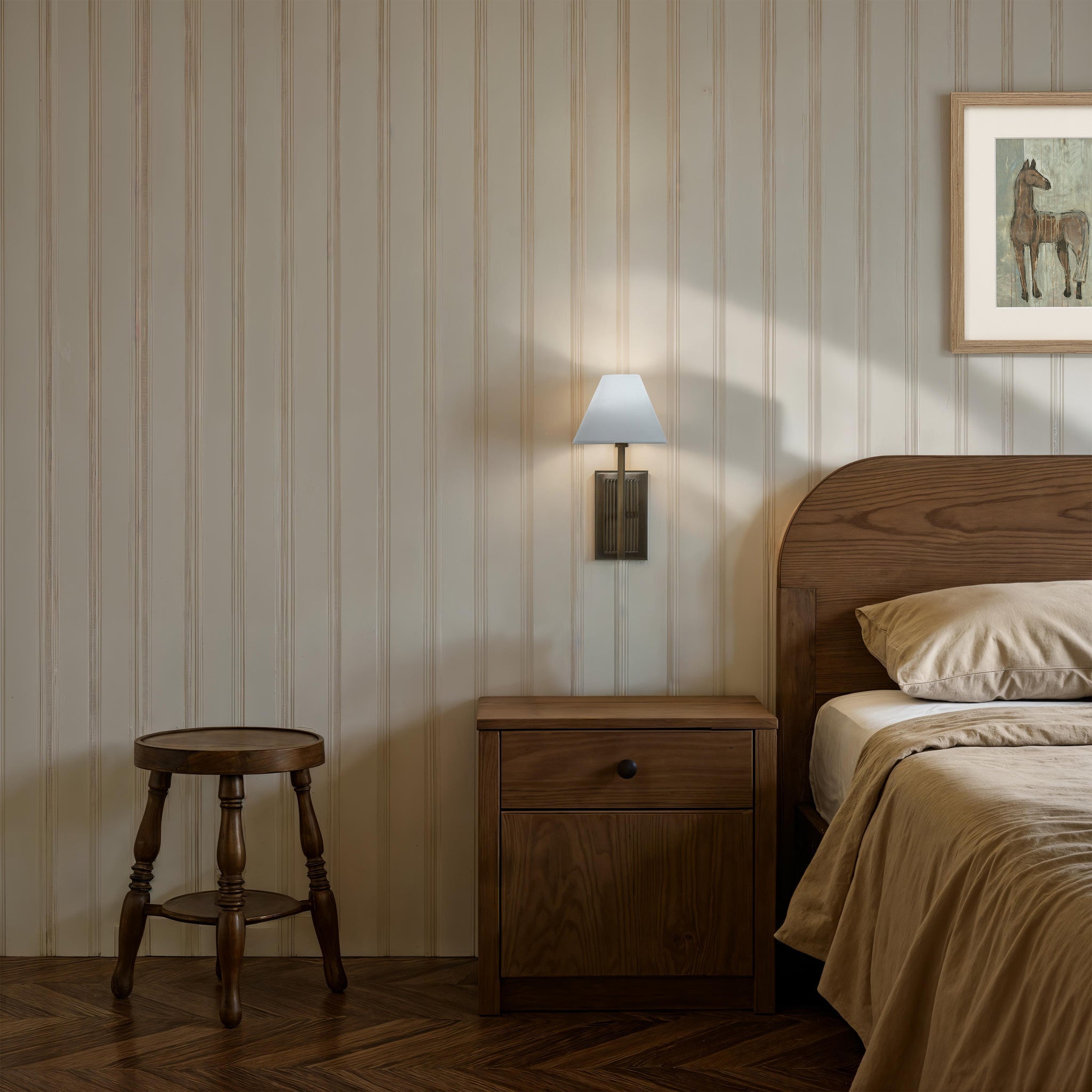 Solaria wall sconce in a rustic bedroom, mounted on striped wall, next to wooden furniture.