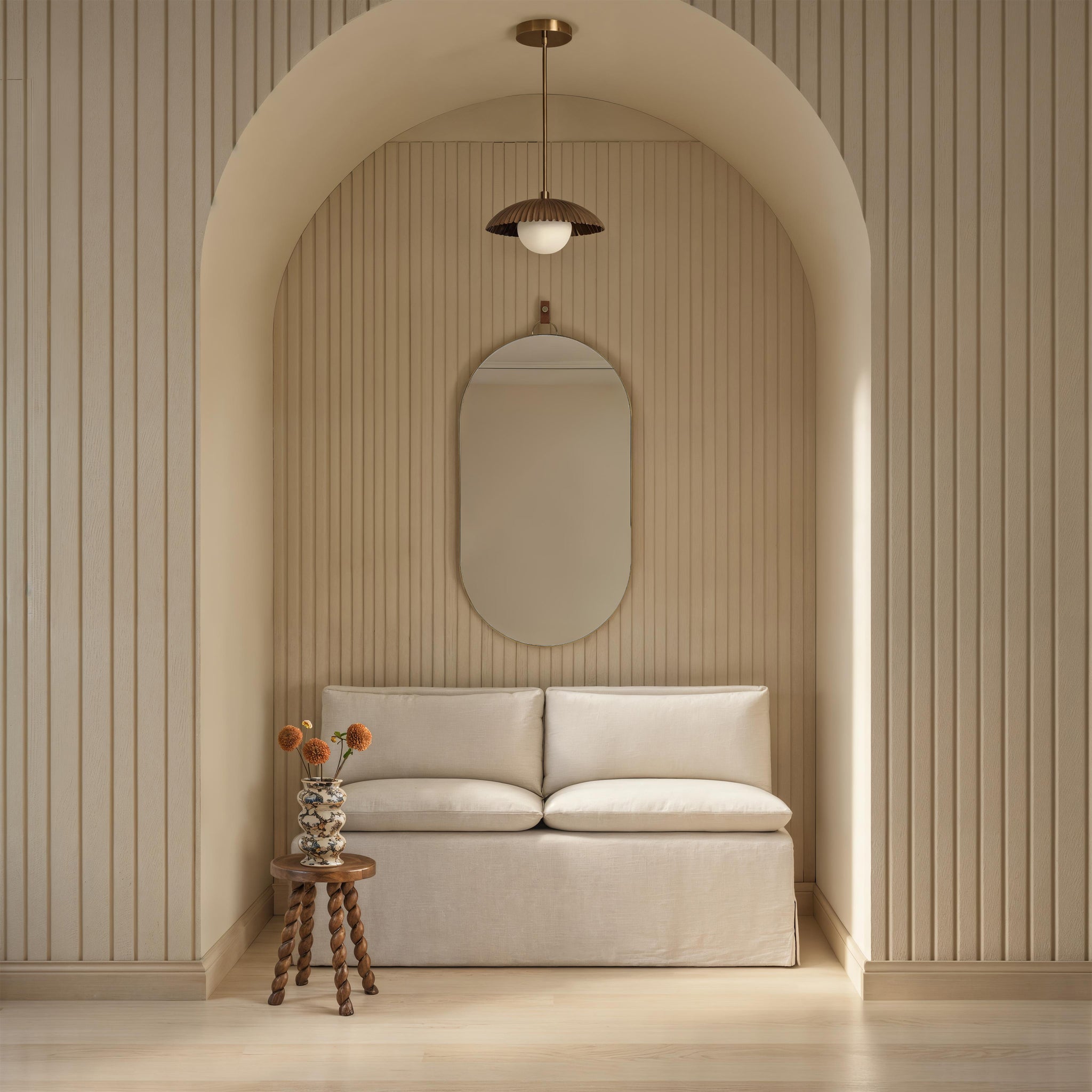 Hudson mirror by Renwil displayed in a modern interior, above a beige sofa.