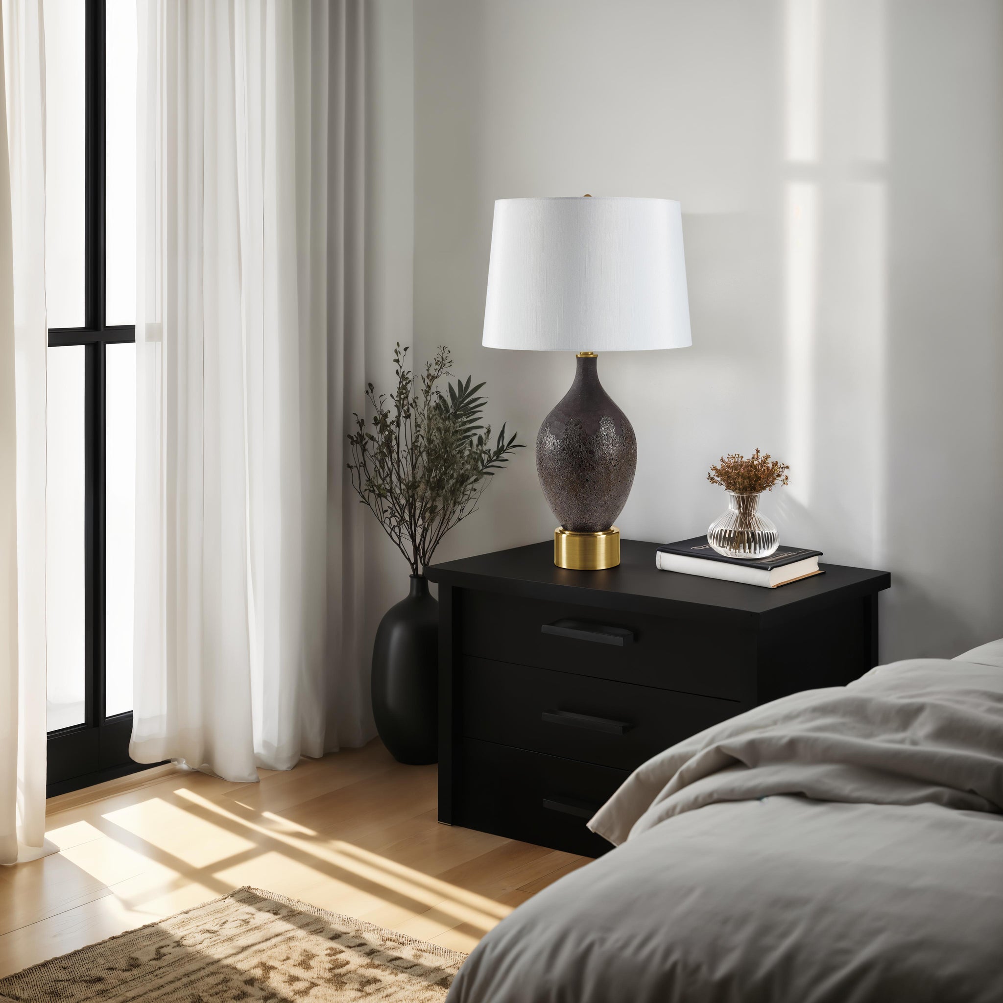 Weldon table lamp on a nightstand in a bedroom setting with natural light