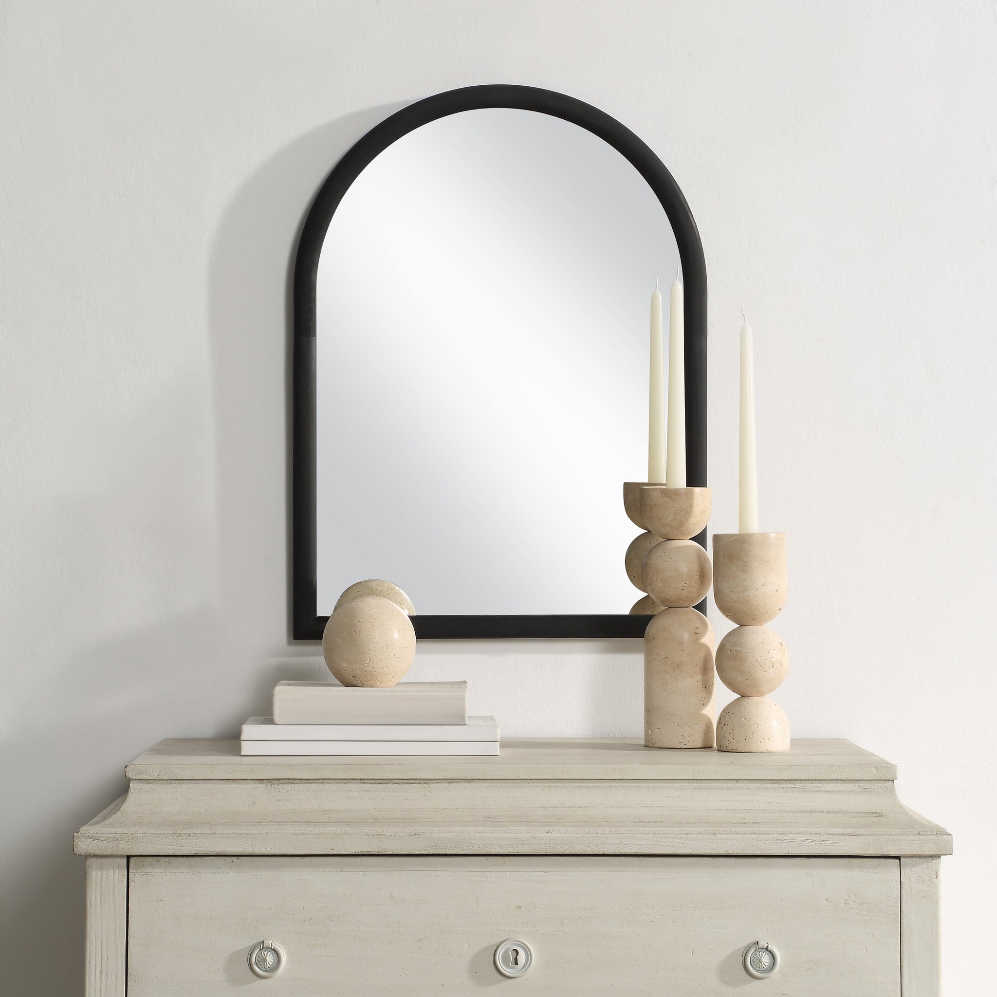 Olfito mirror displayed above a light-colored dresser with decorative items and candles.