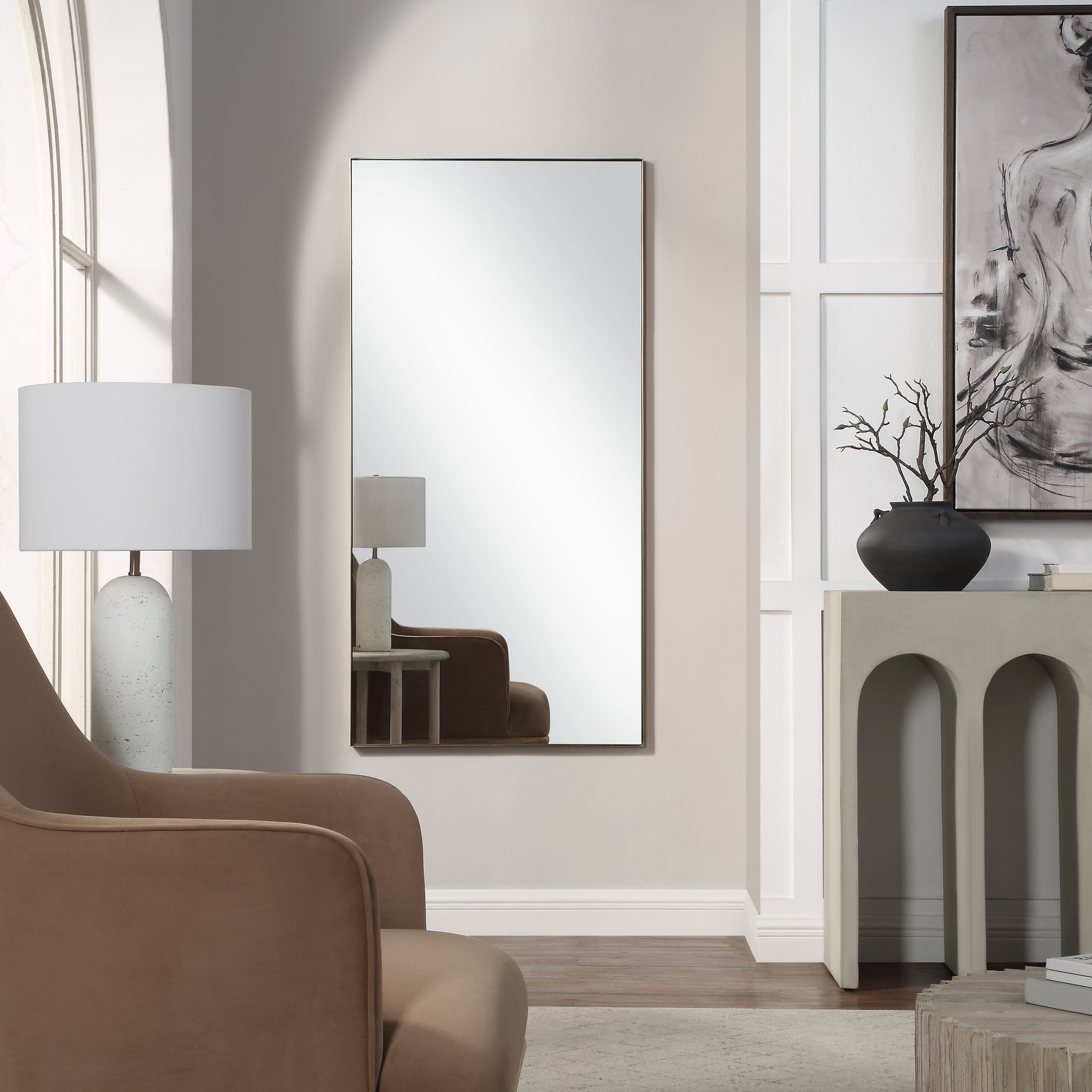 Orrin mirror by Renwil, displayed in a modern living room setting with a lamp and decor.