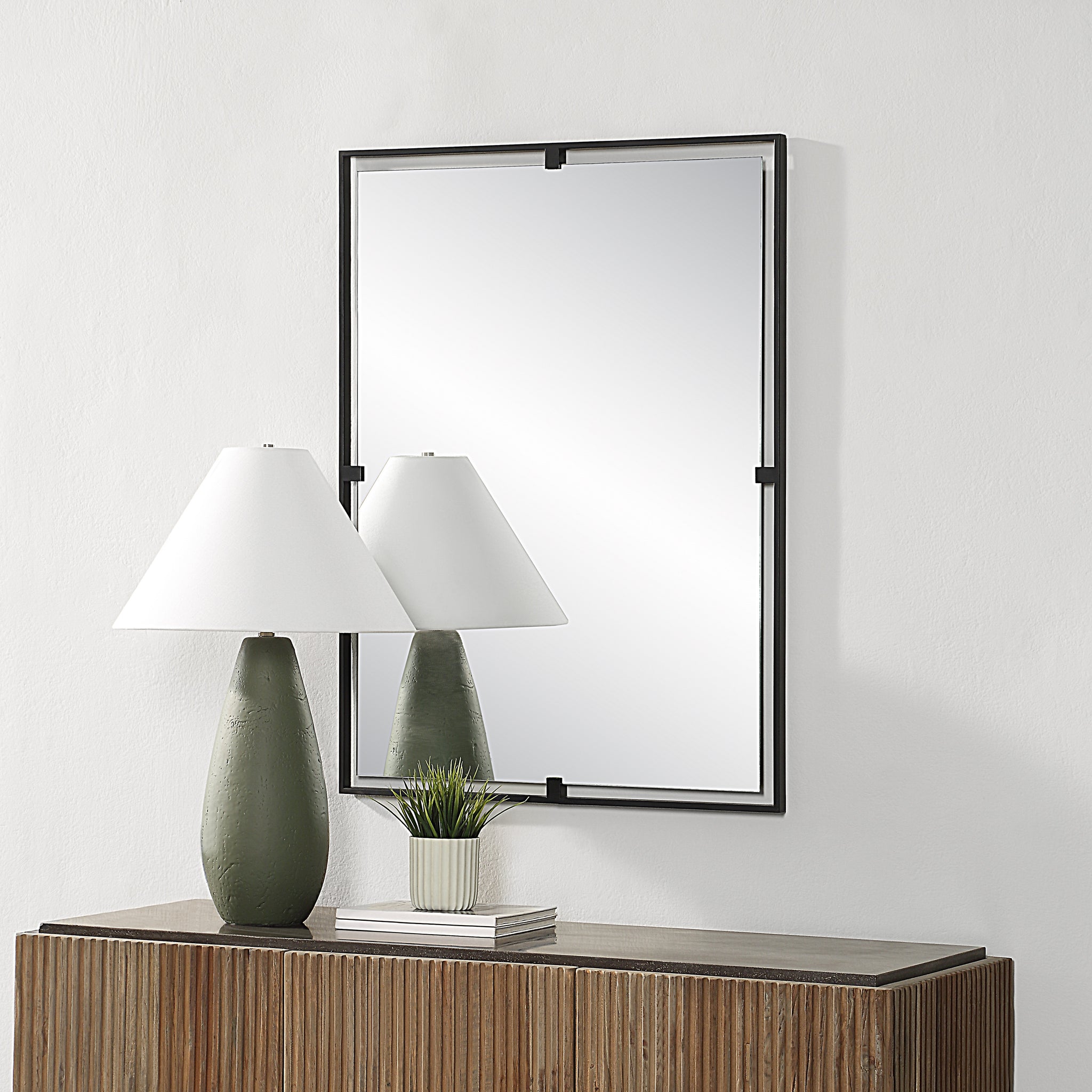 Marco Wall Mirror displayed above a wooden console with a lamp and plant.