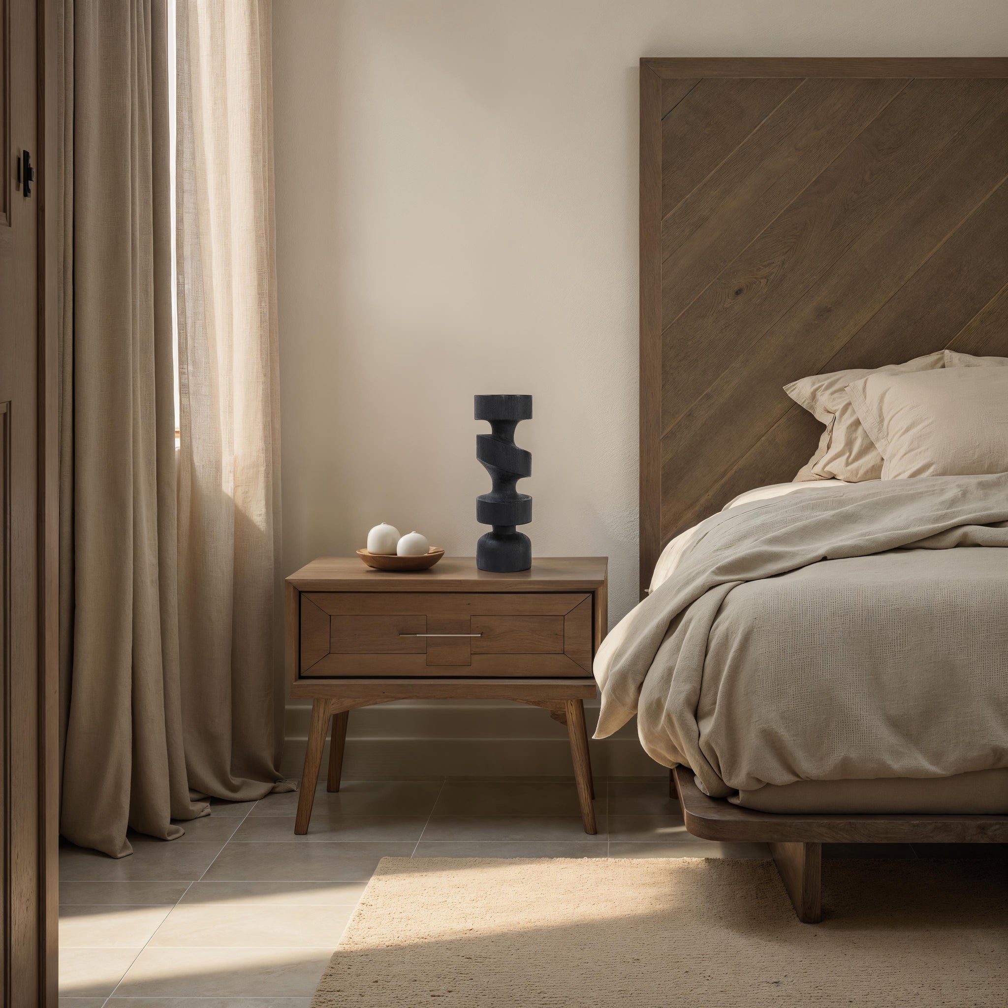 Beckton statue by Renwil on a bedside table, styled with neutral bedding and wooden furniture.