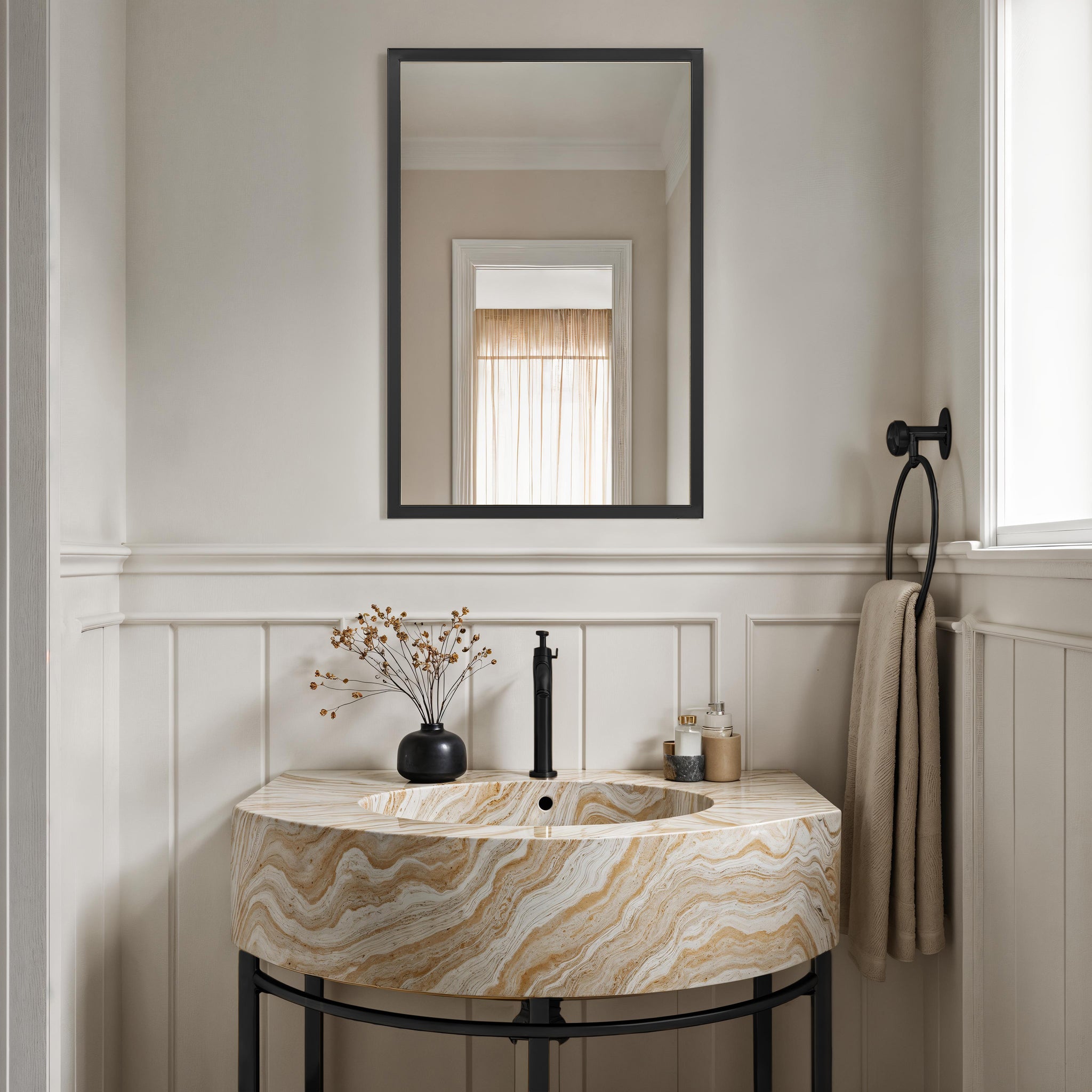 Elvas mirror with a sleek black frame above a stylish marble sink with beige and cream swirls in a modern bathroom setting.