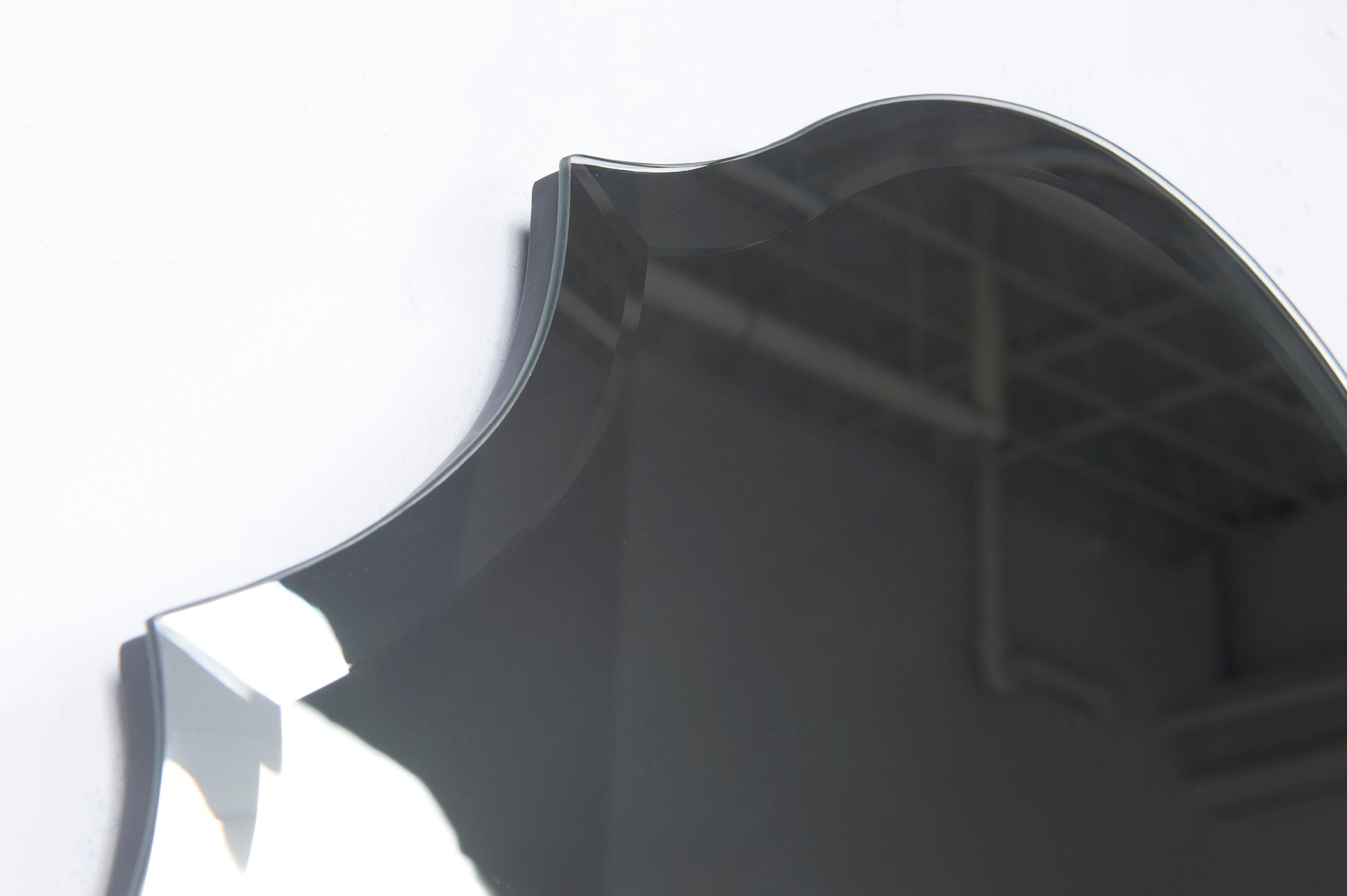 Close-up of Emma mirror by Renwil, showcasing scalloped edges and reflective surface.