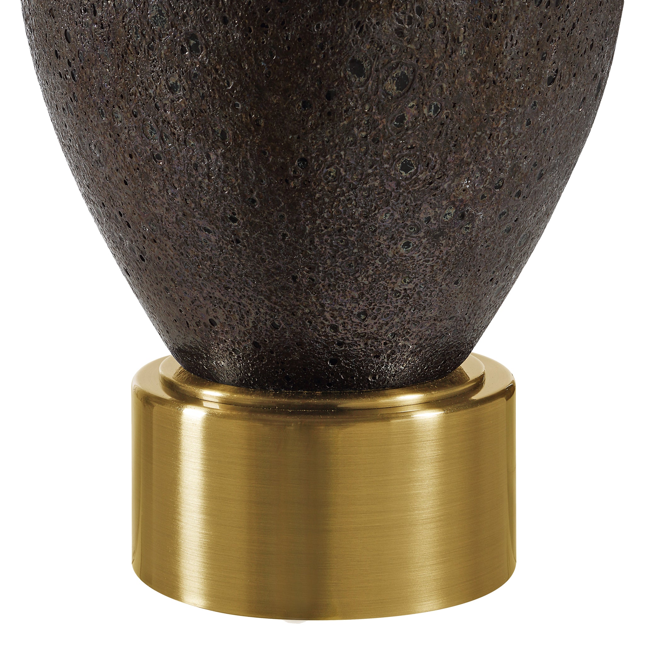 Close-up of Weldon table lamp's dark ceramic base and gold metal accent