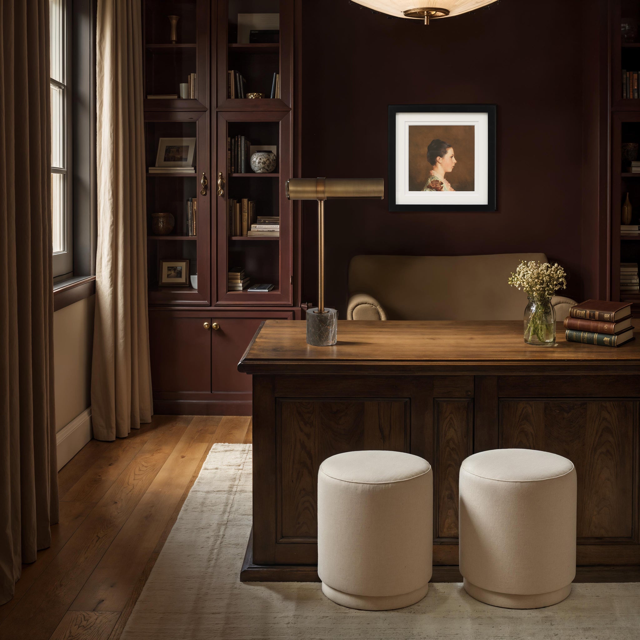 Gusle Table Lamp on a wooden desk in a cozy office, surrounded by books and decorative elements.
