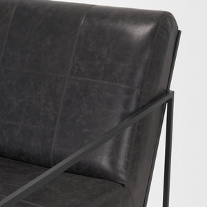 Stratton Gunmetal w/ Genuine Aged Black Leather Upholstered Accent Chair shown from a different angle to reveal its silhouette.