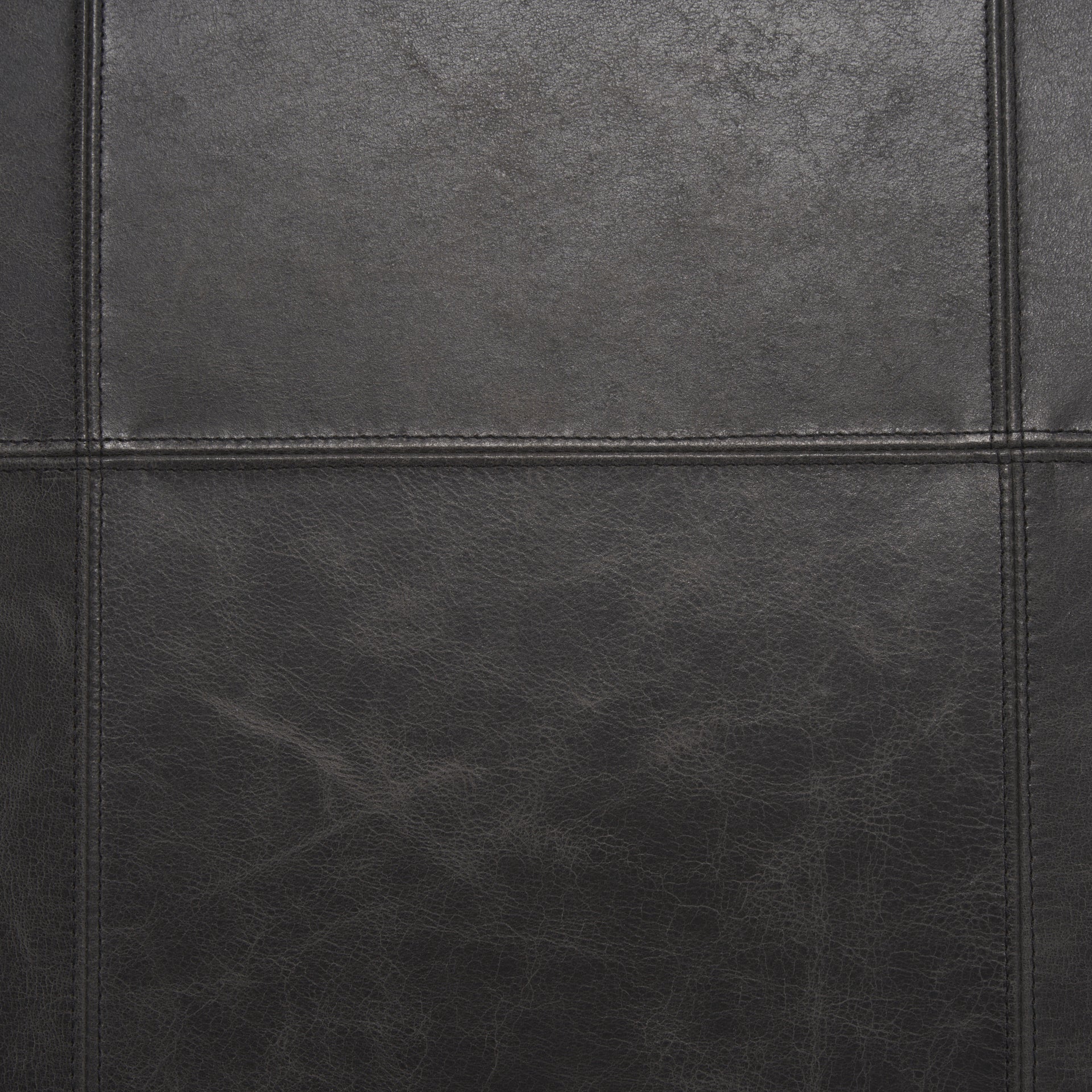 Stratton Gunmetal w/ Genuine Aged Black Leather Upholstered Accent Chair viewed from the side.
