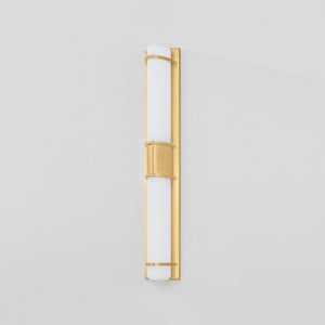 Close-up of the Tottenville Wall Sconce 4.25" x 27" in aged brass showing the arm curve and shade silhouette.
