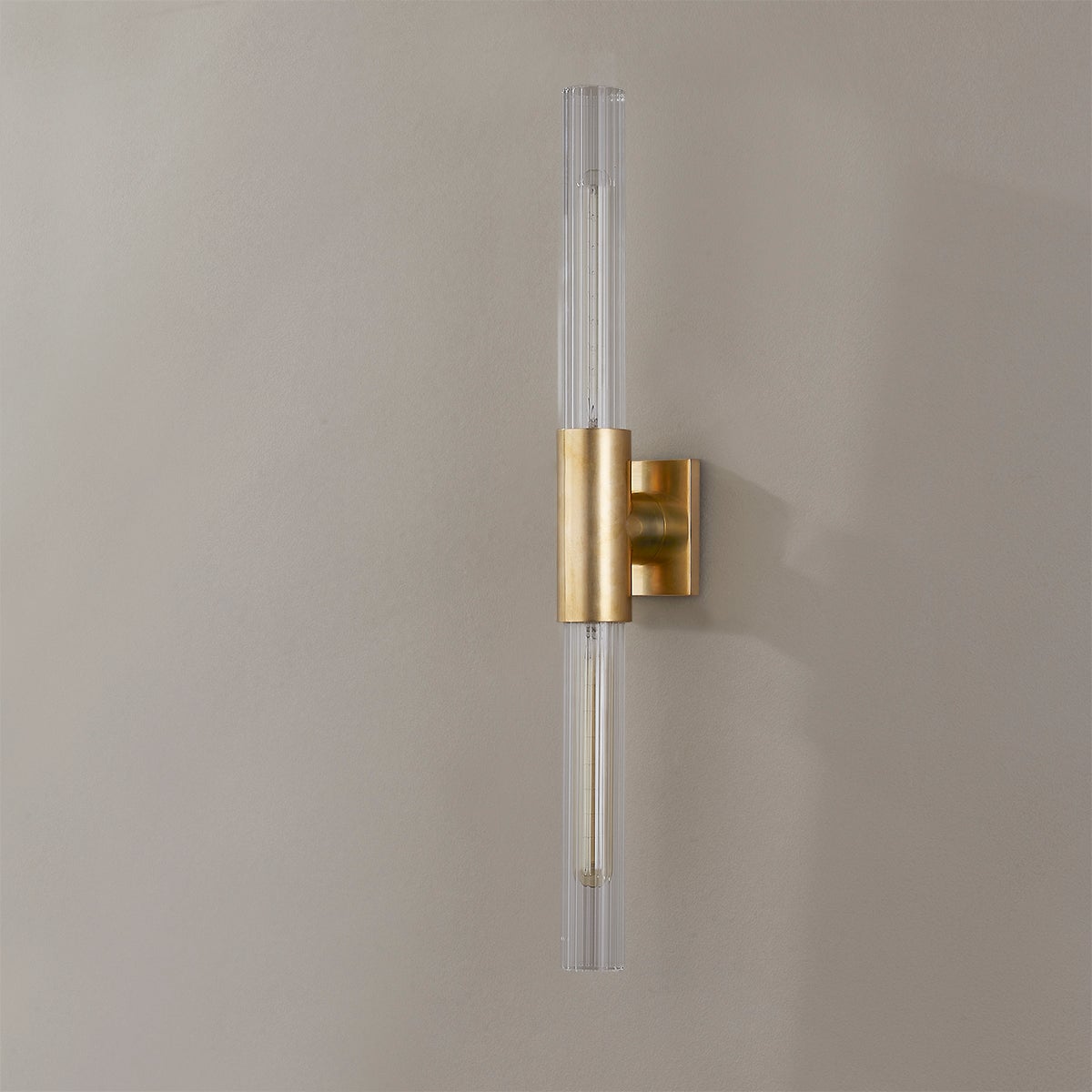 Close-up of the Asher Wall Sconce 4.25" in aged brass showing the arm curve and shade silhouette.