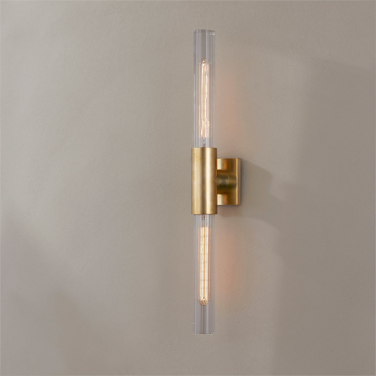 Close-up of the Asher Wall Sconce 4.25" in aged brass showing the arm curve and shade silhouette.